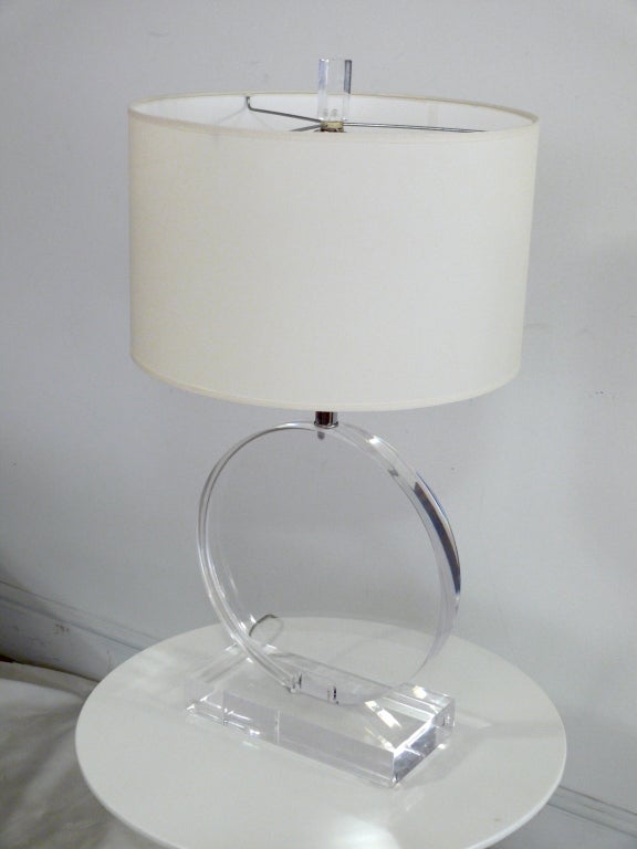 Incredible Lucite table lamp with concealed wiring. Nickel hardware, 13.75 in. diameter disc sitting on a beautiful thick base. No scratches or chips. Shade not included.