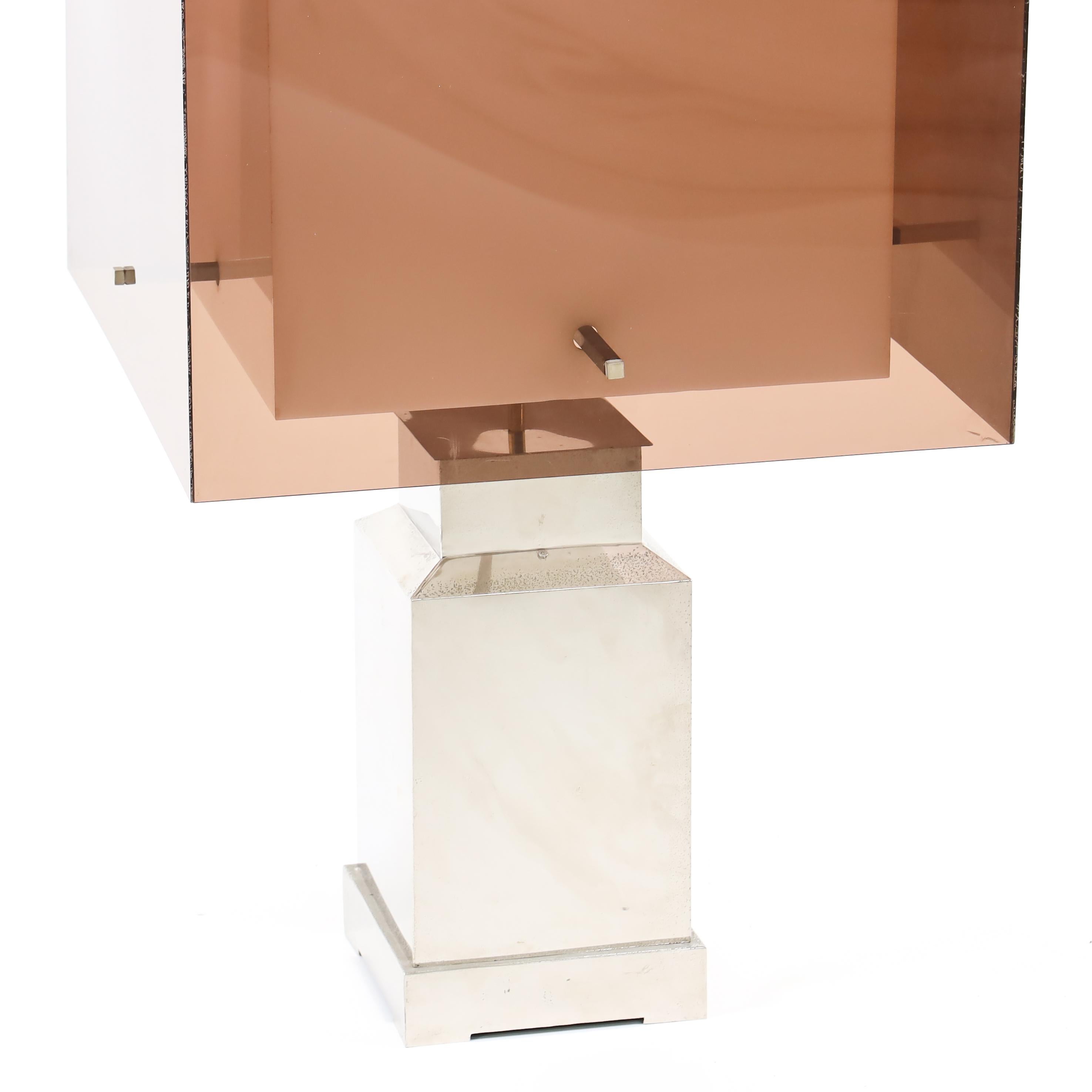 Large table lamp on a socketed stand made of metal with cubic plexiglass shade in brown and white.