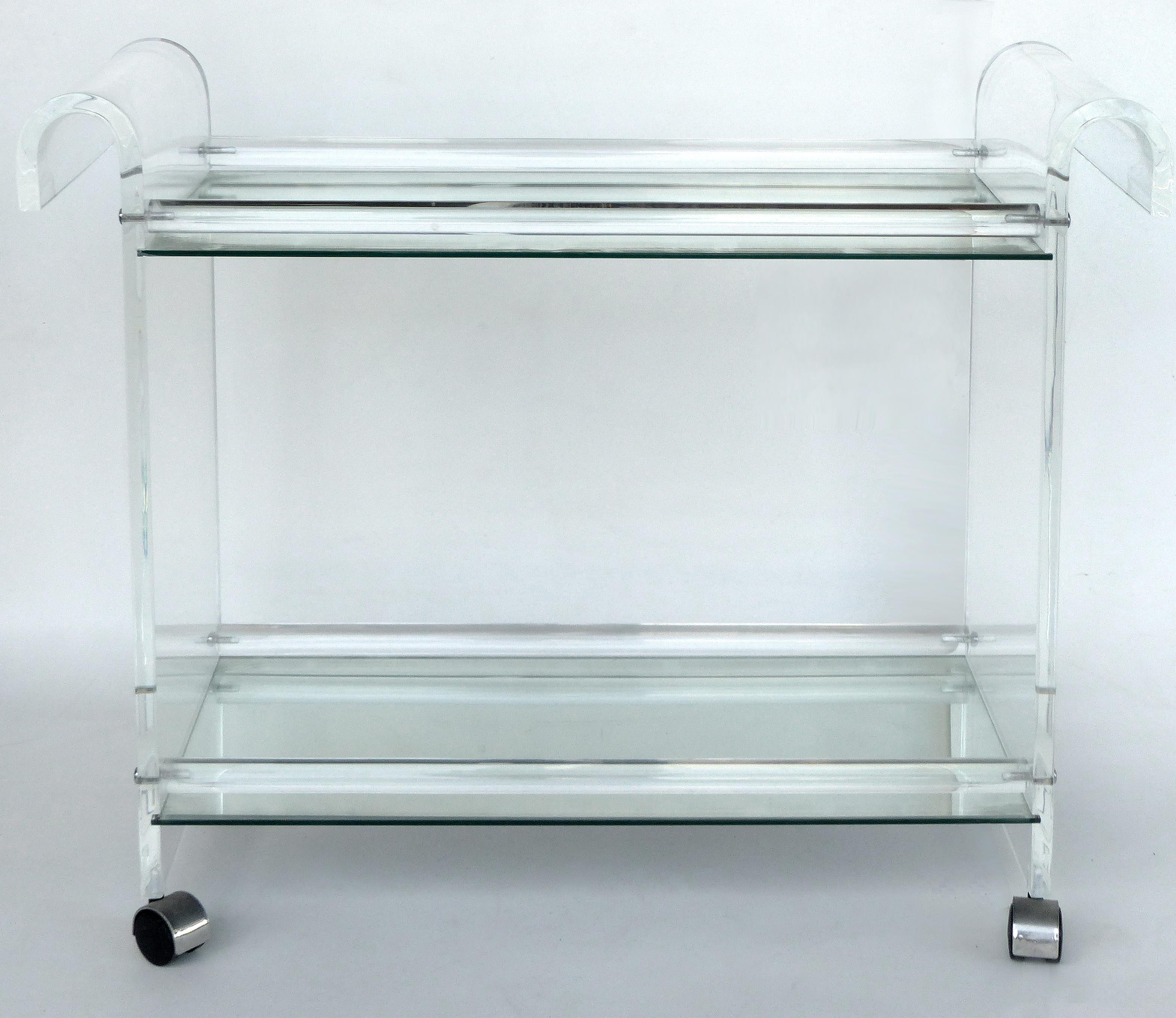 Mid-century Modern Lucite Tea or Bar Cart on Casters

Offered is a Lucite bar or tea cart with curved end handles and inset mirror shelves. The cart rolls nicely and directs from either end. The glass shelves have minor age wear but are easily