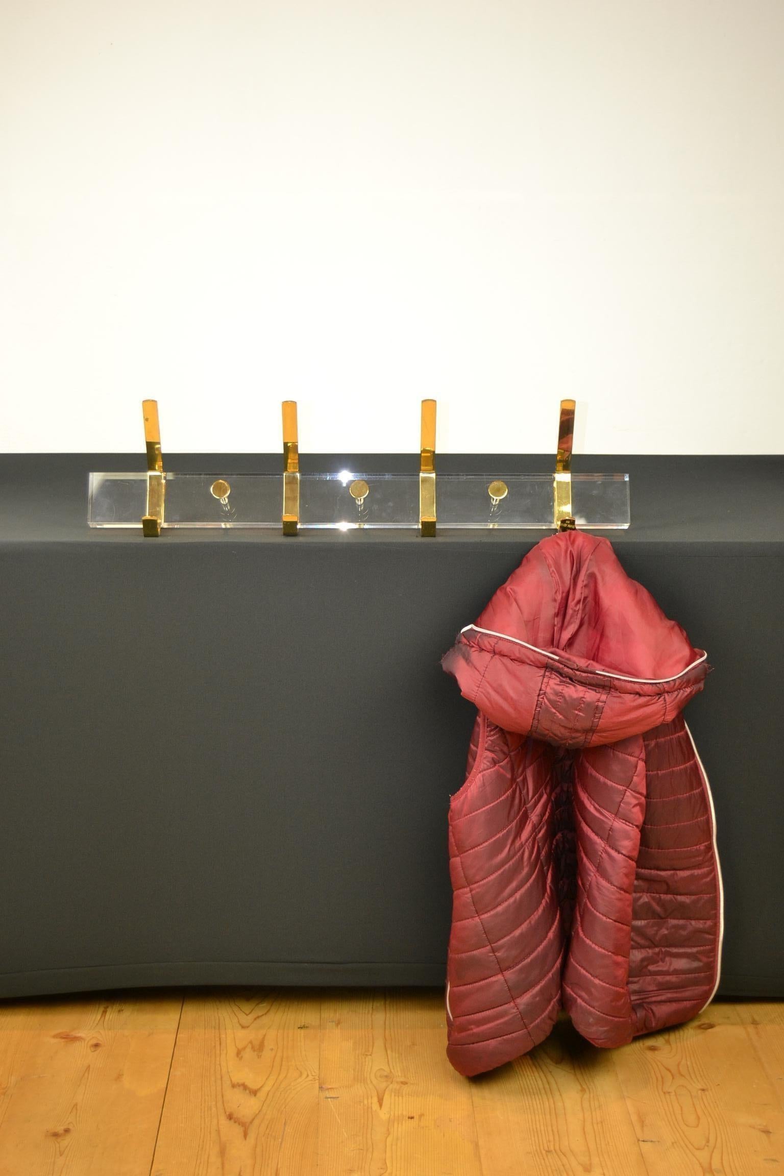 1970s wall coat rack from Lucite with brass hardware.
This acrylic with brass wall coat rack offers space for 4 coats or towels.
A modern coat rack made from Plexiglas.

This Italian coat rack is in used condition with normal traces on the