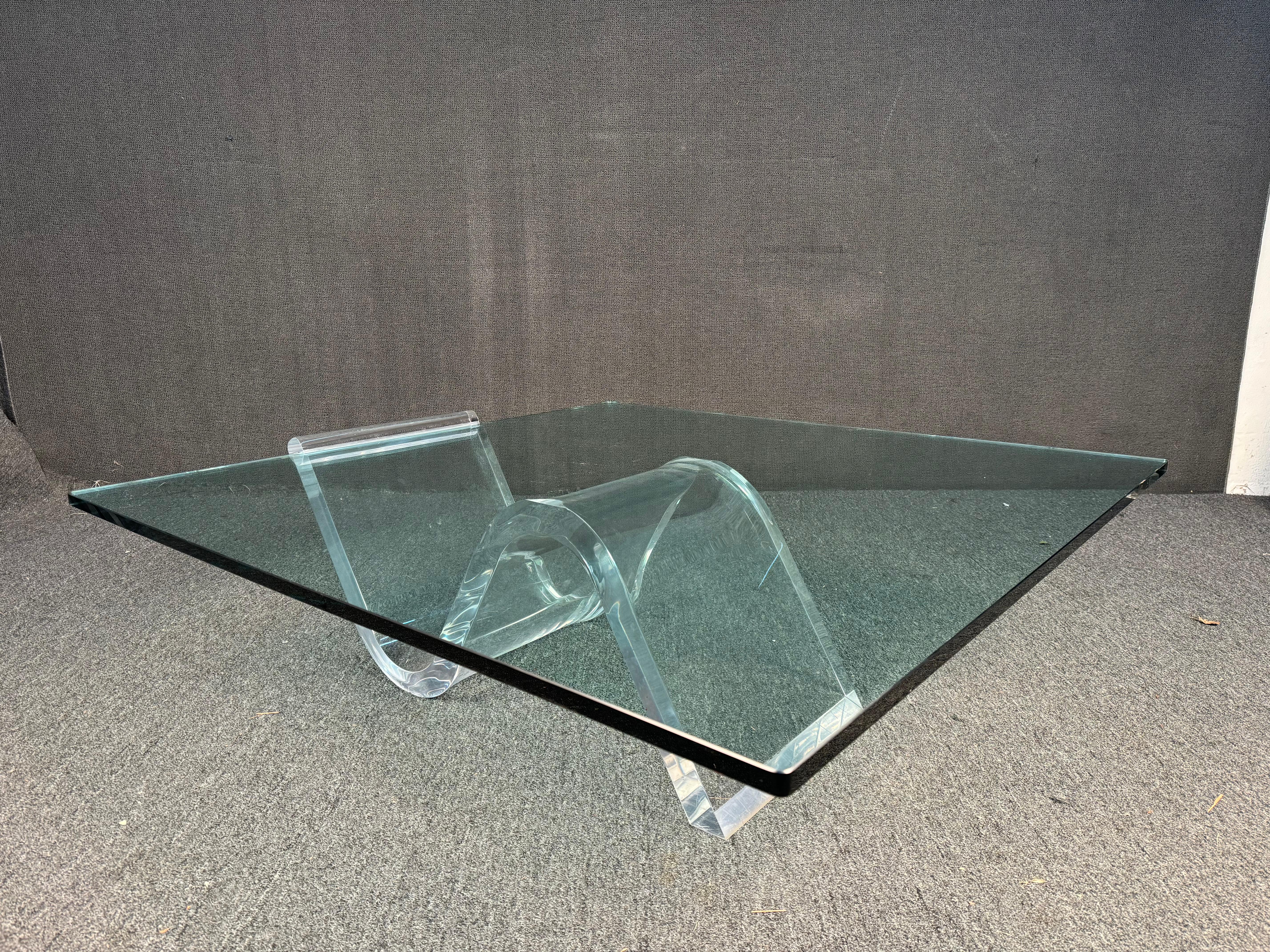  Superbe table basse de style Mid-Century Modern, conçue pour apporter à la fois style et fonctionnalité à votre intérieur. La table est dotée d'un plateau de verre rectangulaire élégant qui offre une vue dégagée sur sa base unique, où les courbes