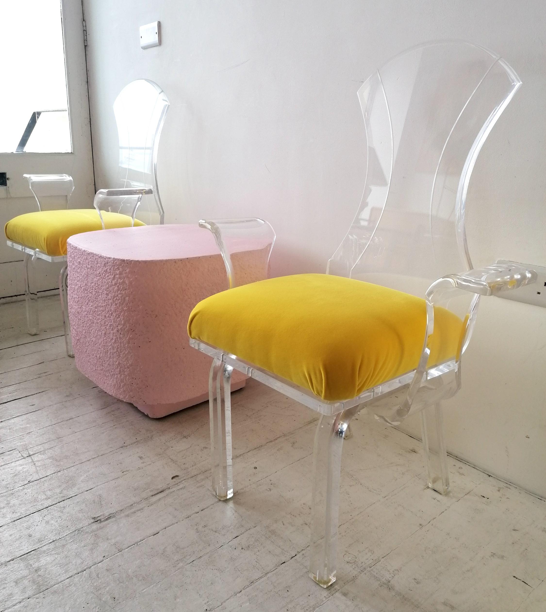 Late 20th Century Lucite wing-arm dining or side chairs with yellow velvet seat pads, USA 1980s