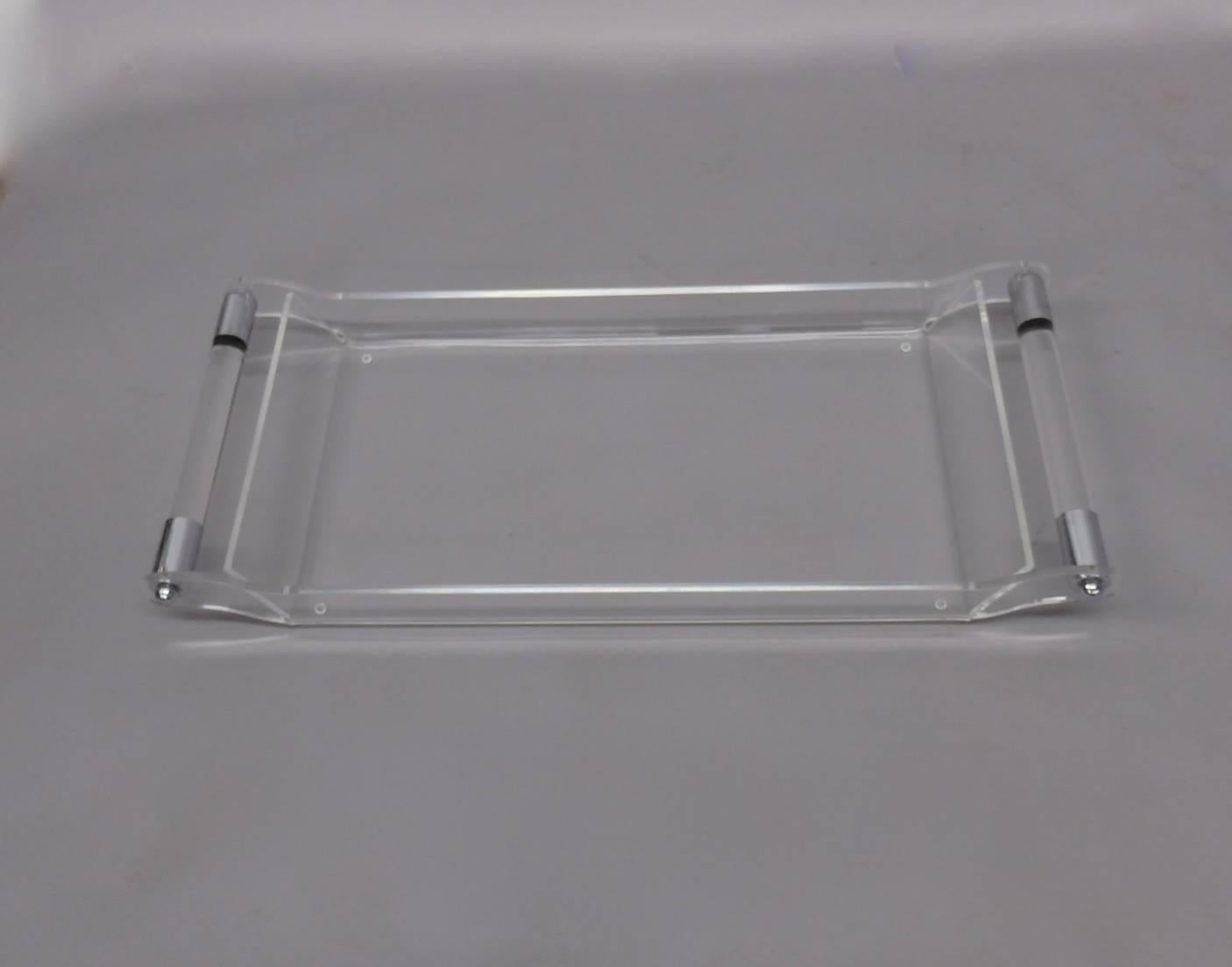 Cleverly formed Lucite tray with chrome trimmed Lucite bar handles. Slight scratches.