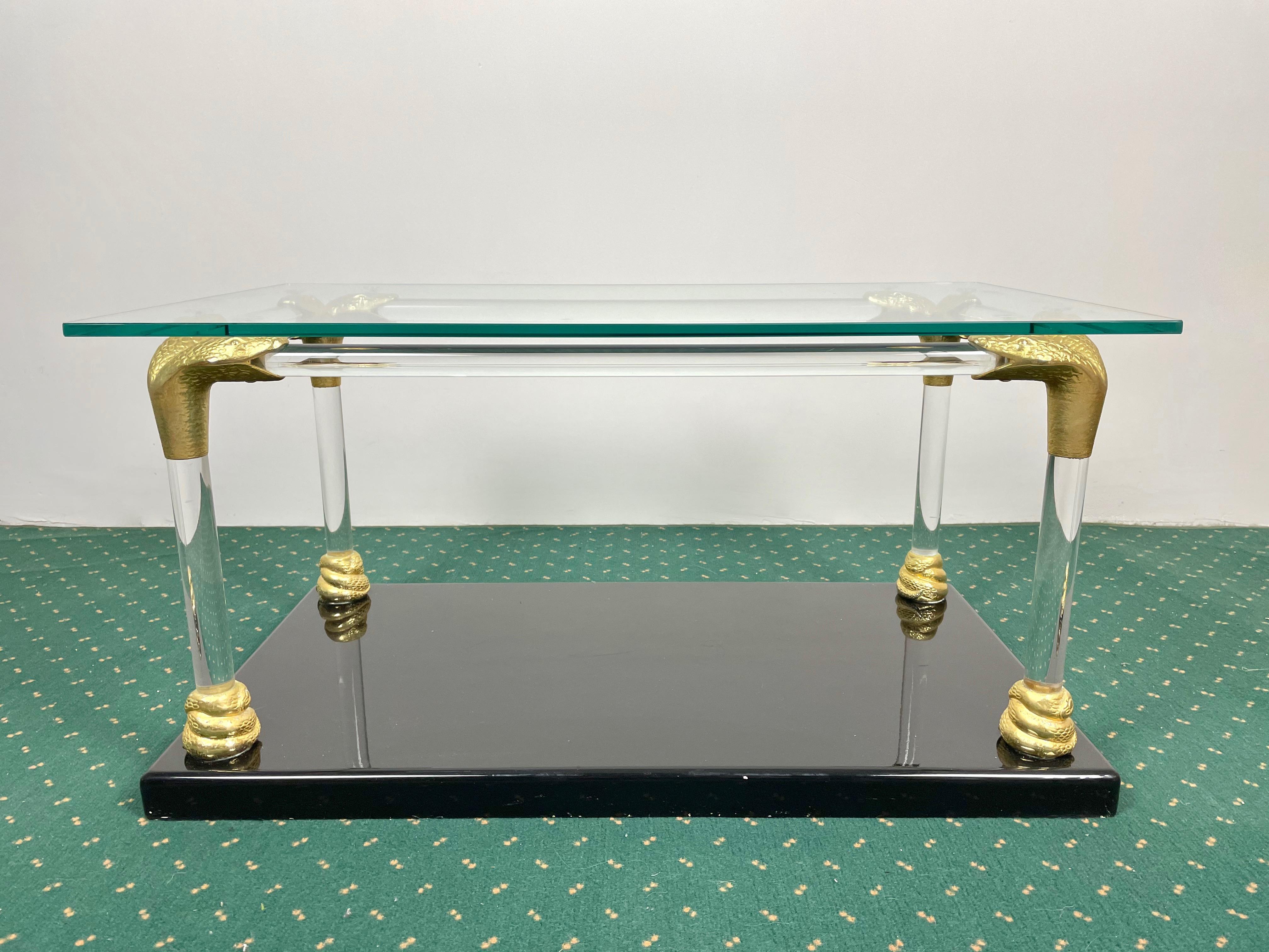 Coffee side table with snakehead brass corners composed of two shelves, one in Lucite and one in lacquered wood. Made in Italy in the 1970s.