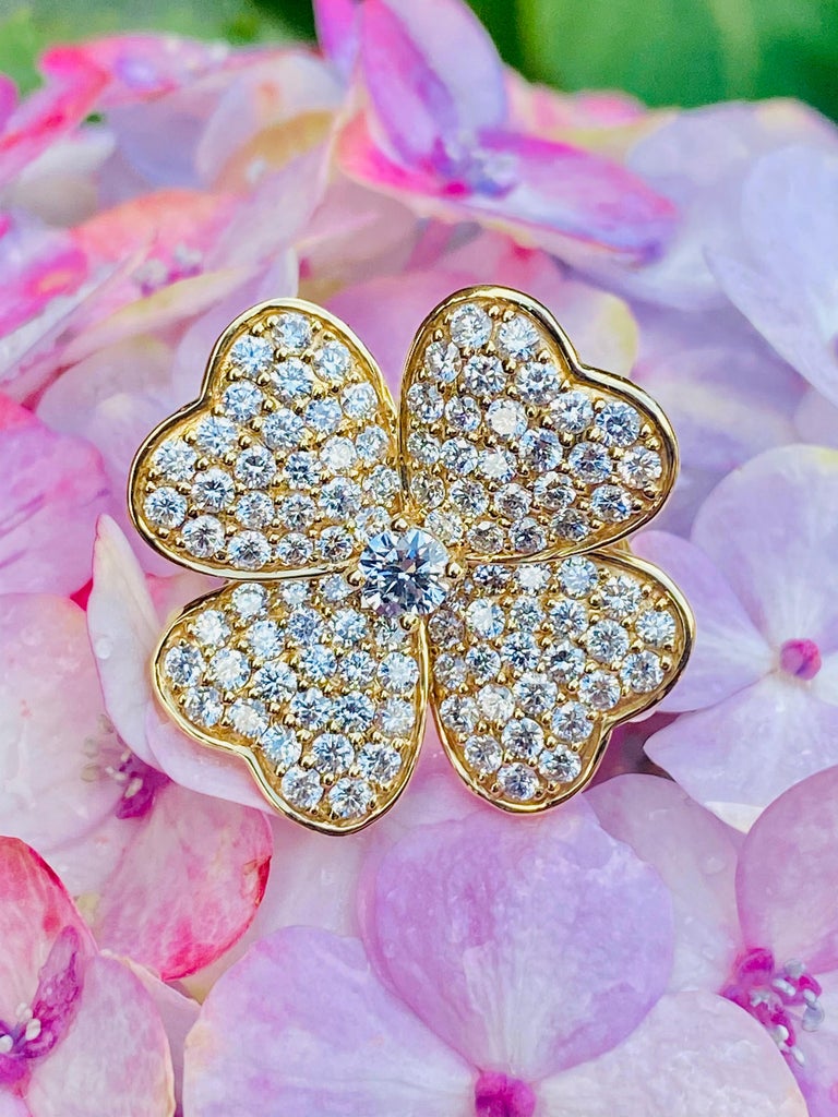 The luck of the Irish will be with you with this exquisite 14 karat yellow gold ring shaped like a 4 leaf clover shamrock.  Ring features a prong set round brilliant diamond center stone and 4 heart-shaped petals covered in approximately 100 pave