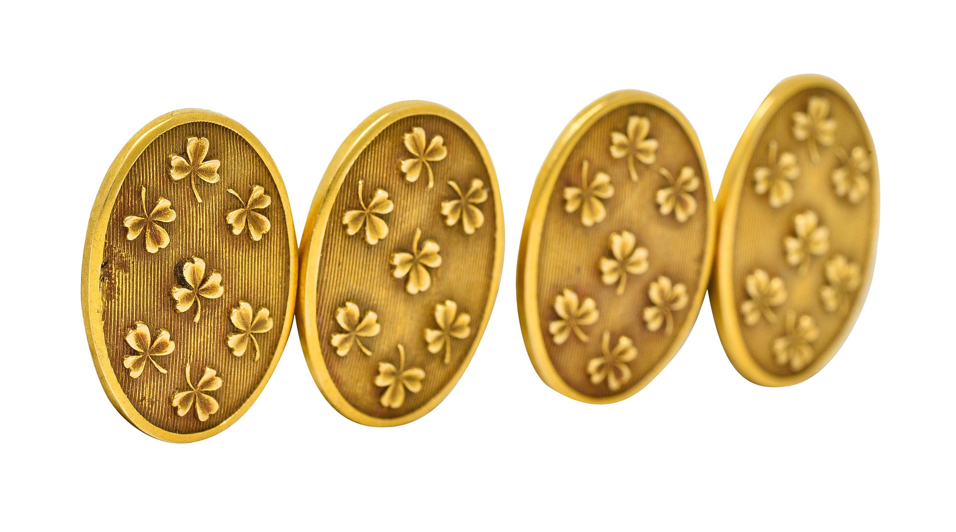 Link style cufflinks terminate as ovals with a deeply ribbed texture

Emblazoned with fanciful and highly rendered clovers

With maker's mark and stamped 14K for 14 karat gold

Circa: 1905

Length: 7/8 inch

Oval measures: 1/2 x 3/4 inch

Total
