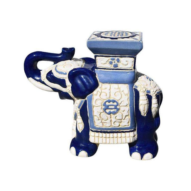 Beautiful blue and white ceramic elephant plant stand or garden statue. This piece features an elephant shown with the trunk up. (In Southeast Asia, a trunk up means good luck!) 

Elephant Symbolism. Protection, good luck, wisdom, and fertility