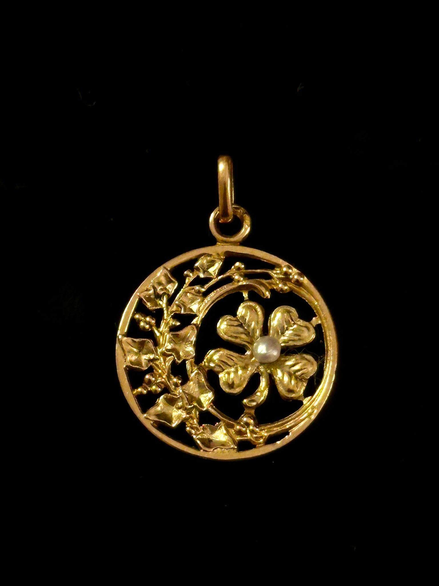 Lucky Clover Charm Pendant dated Art Nouveau period circa 1895-1915 and is created in France. Pendant is made of 18k yellow gold and decorated with one seed perle. 
This pendant belongs to the highly collectible pieces of “Lucky Charms” and “Love