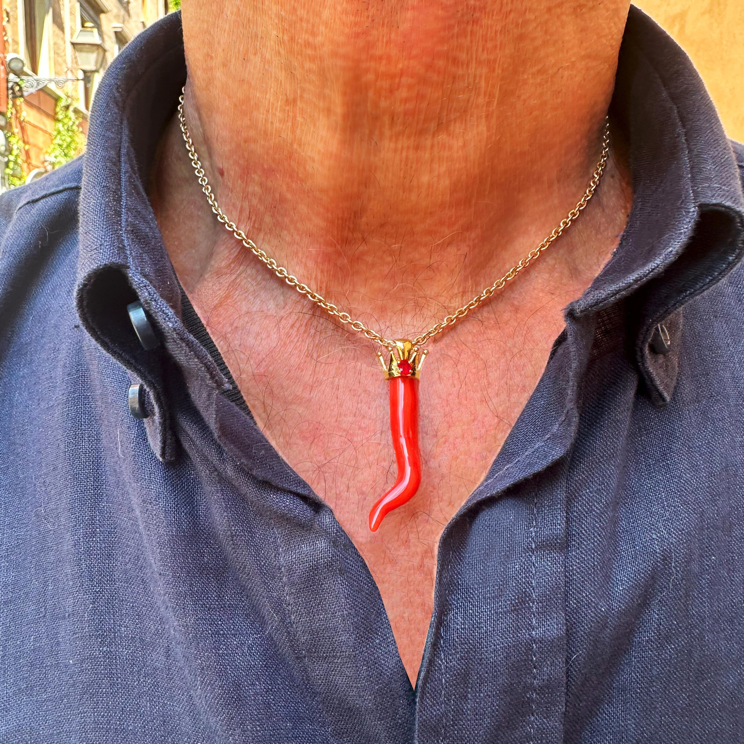 This beautiful red coral horn comes from the Italian sea and then was mounted with an 18 Kt gold crown and a ruby by our goldsmiths. 
Going back in time, we begin to find traces of coral in the 3400 BC; the populations of that historic period, used