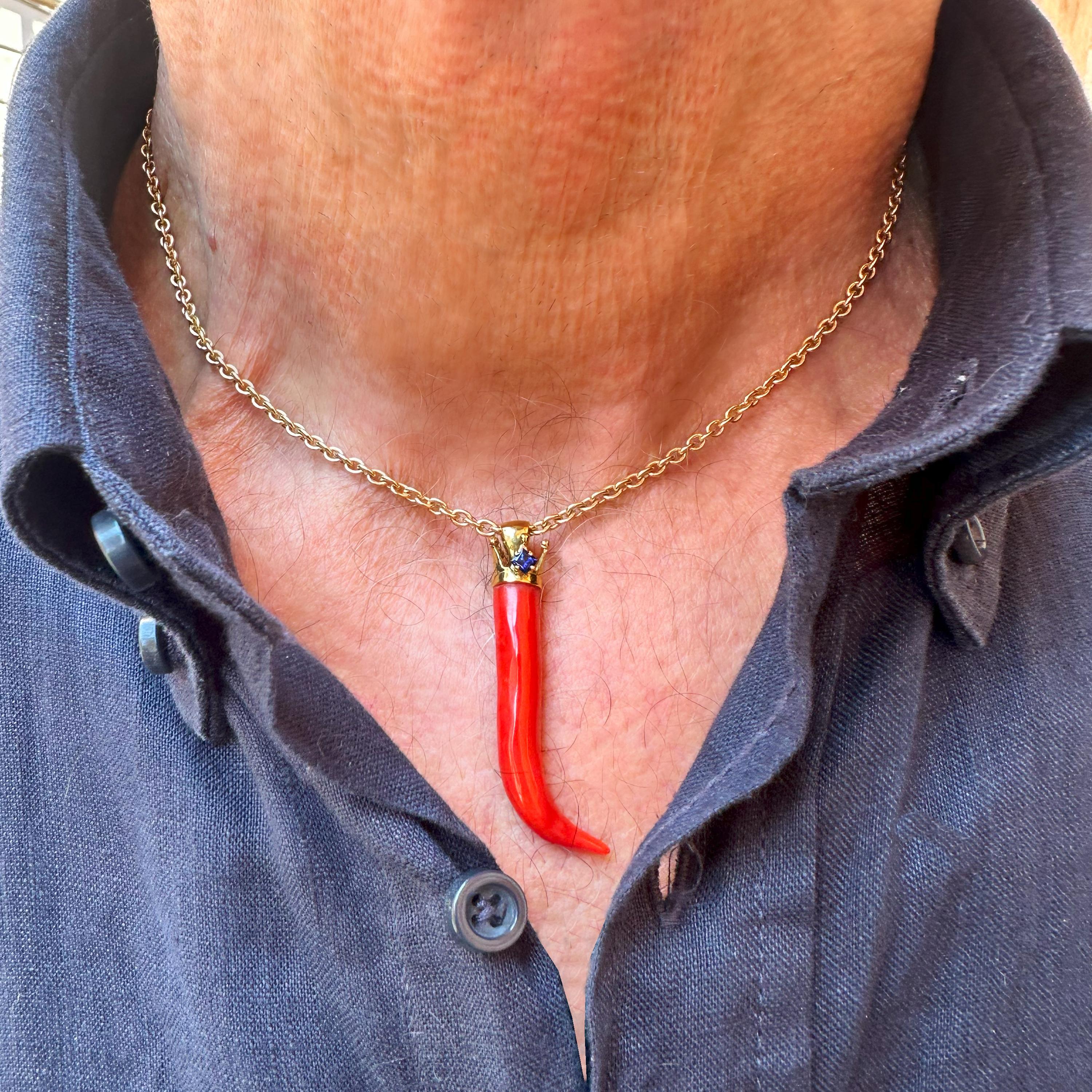 This beautiful red coral horn comes from the Italian sea and then was mounted with an 18 Kt gold crown and a sapphire by our goldsmiths. 
Going back in time, we begin to find traces of coral in the 3400 BC; the populations of that historic period,