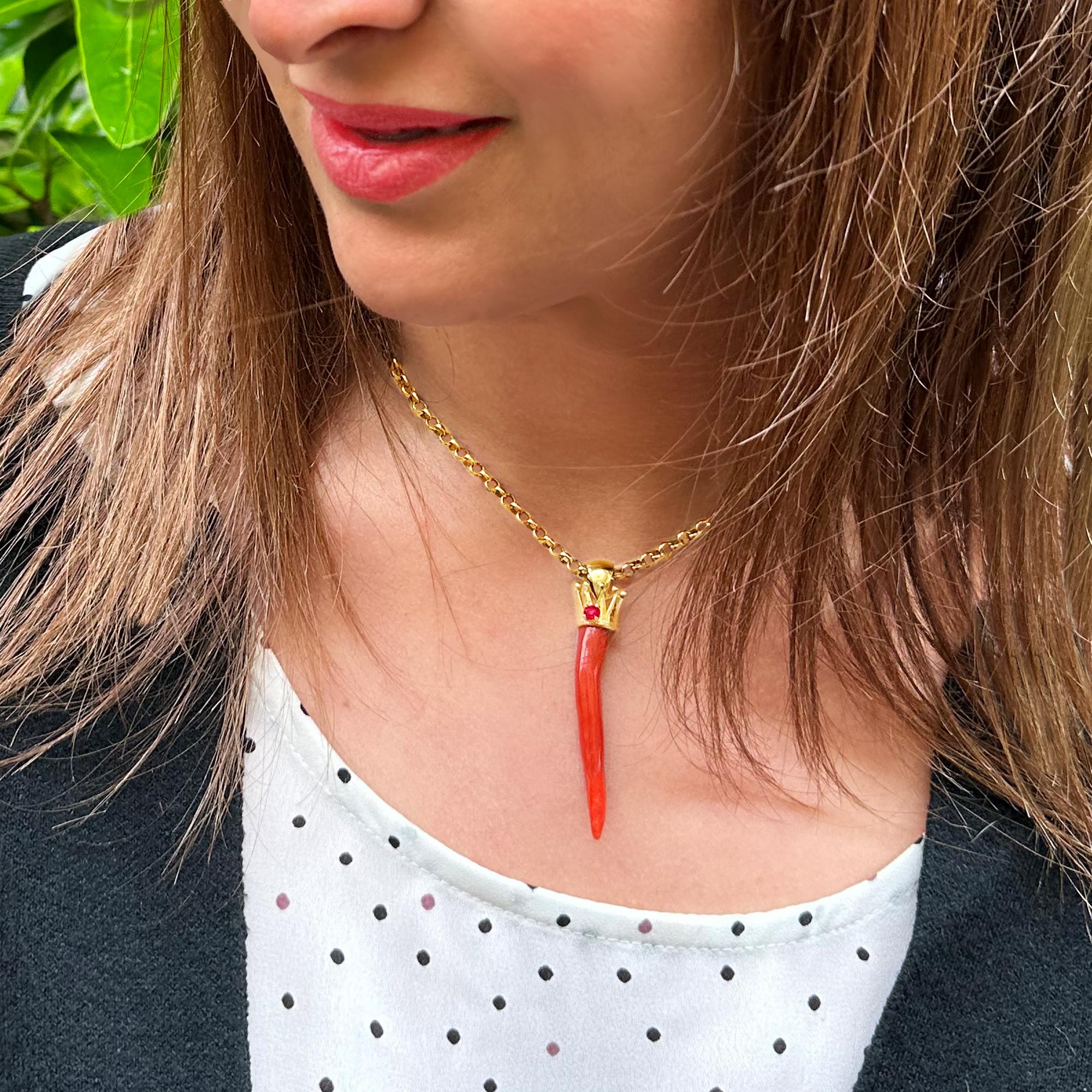 This beautiful red coral horn comes from the Italian sea and then was mounted with an 18 Kt gold crown and a ruby by our goldsmiths. 
Going back in time, we begin to find traces of coral in the 3400 BC; the populations of that historic period, used