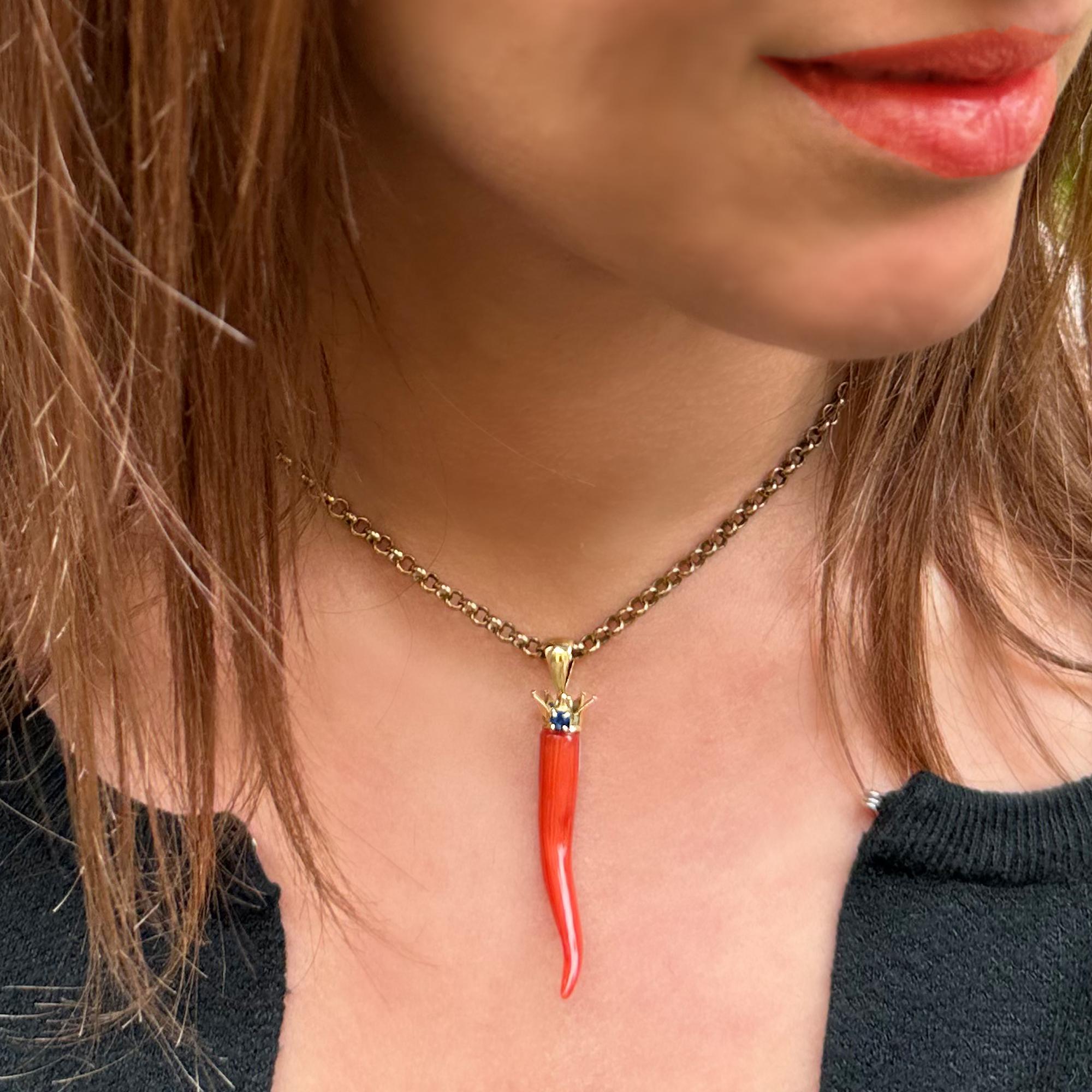 This beautiful red coral horn comes from the Italian sea and then was mounted with an 18 Kt gold crown and a sapphire by our goldsmiths. 
Going back in time, we begin to find traces of coral in the 3400 BC; the populations of that historic period,