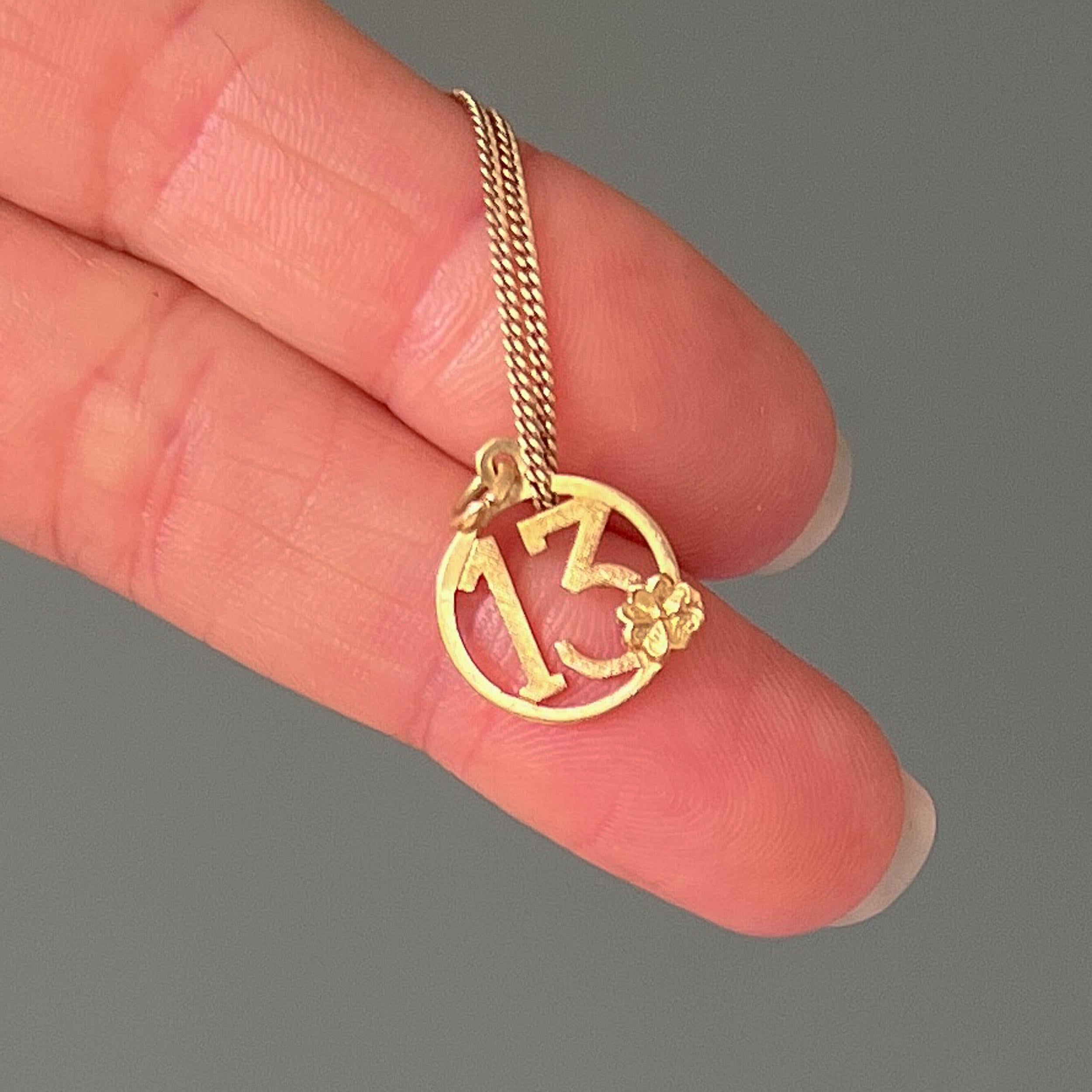 number 13 gold pendant