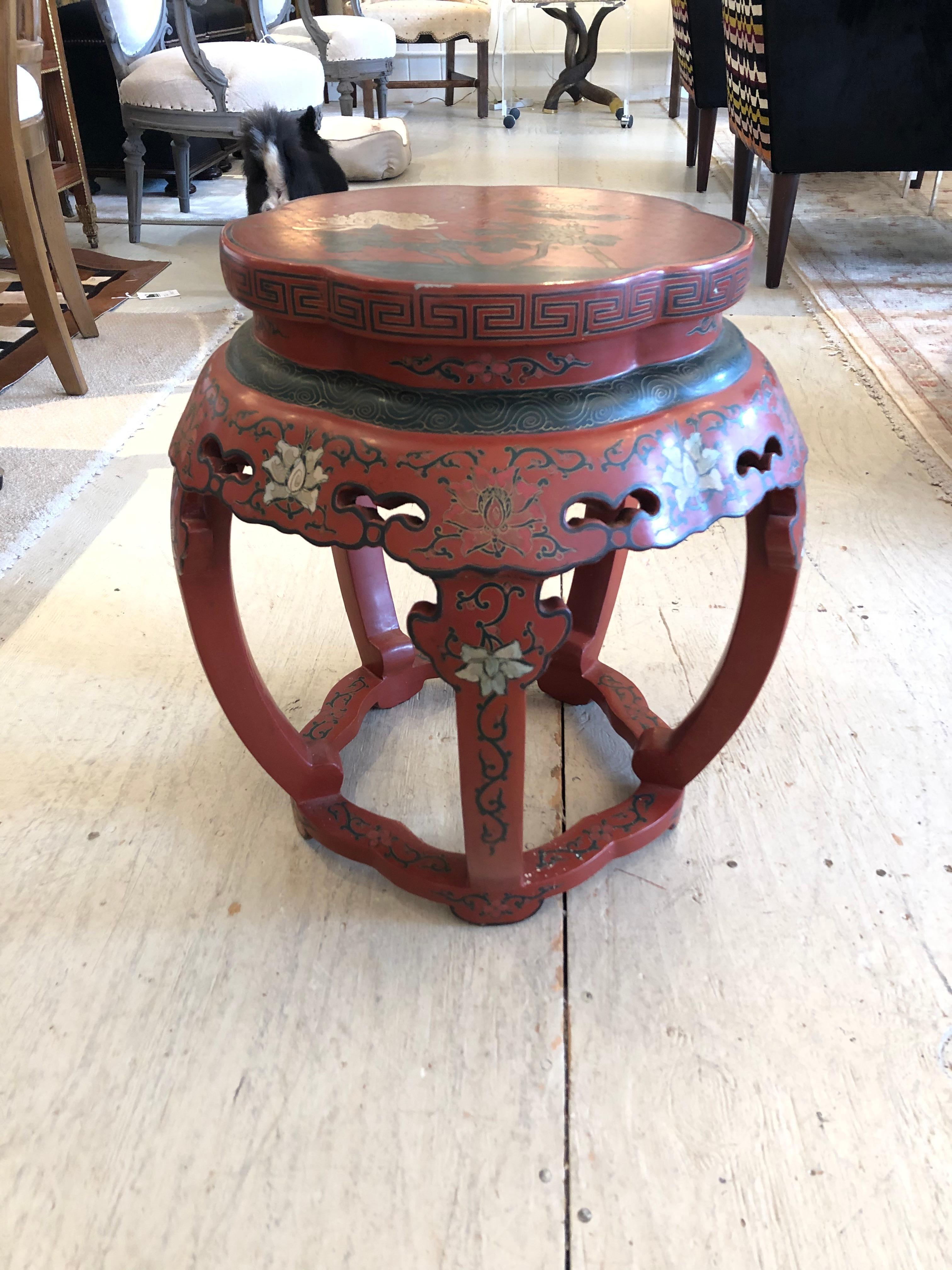 A striking side or occasional table in lucky Chinese red, hand painted with meticulous decoration including bird and greek key design. Table surface is 13.5 diameter.