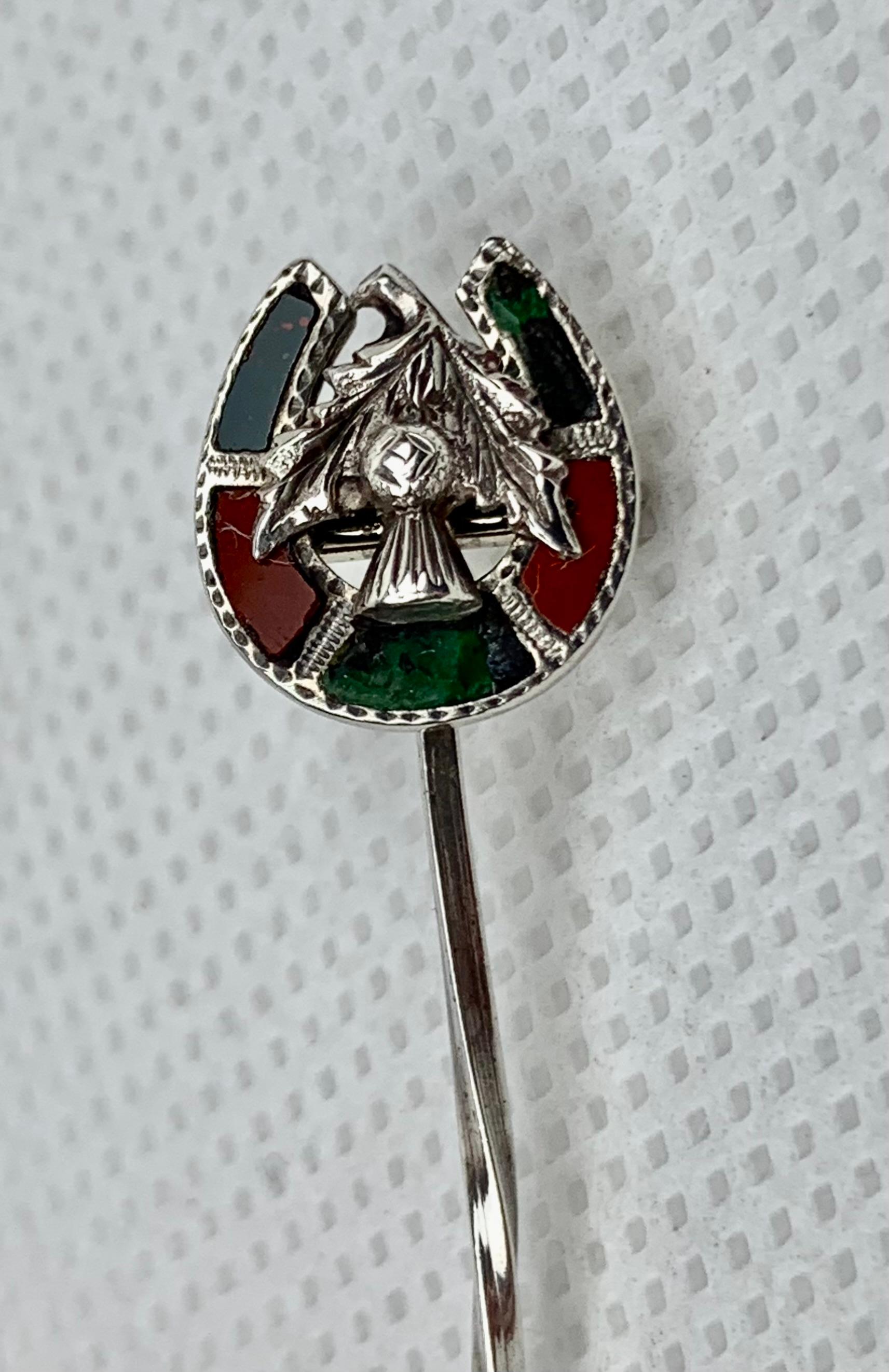 Lucky Scottish sterling silver horseshoe stickpin.  The hand engraved top set with green Bloodstone from the Isle of Rum and red Campsie Fells Jasper from Stirlingshire is hinged so that the horseshoe can be facing up or down.  There are various