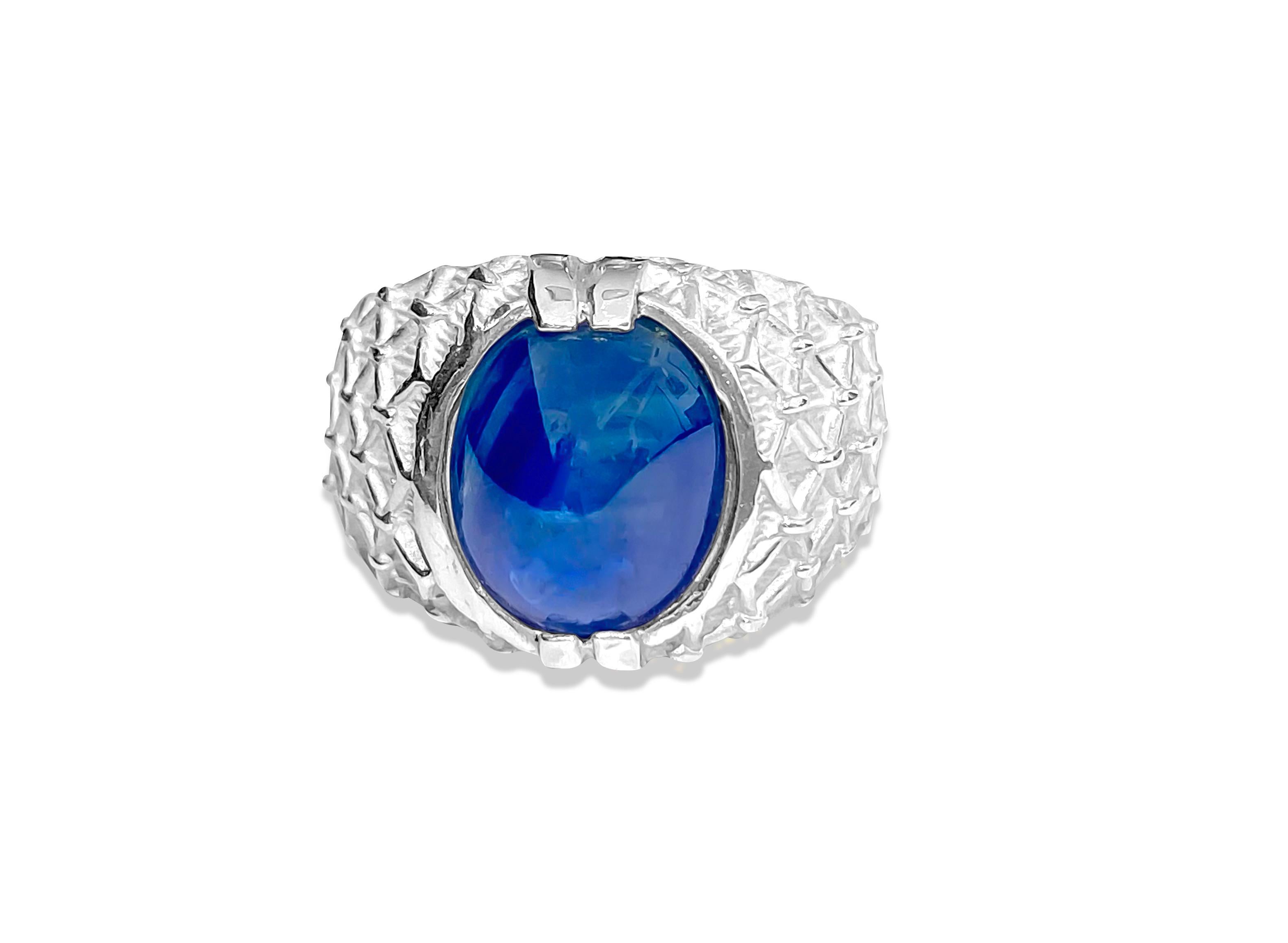 Introducing this captivating ring crafted from sterling silver, featuring a striking 6.00 carat cabochon-cut blue sapphire, securely set in prongs. With its deep blue hue and natural earth-mined origin, this sapphire adds a touch of elegance to any