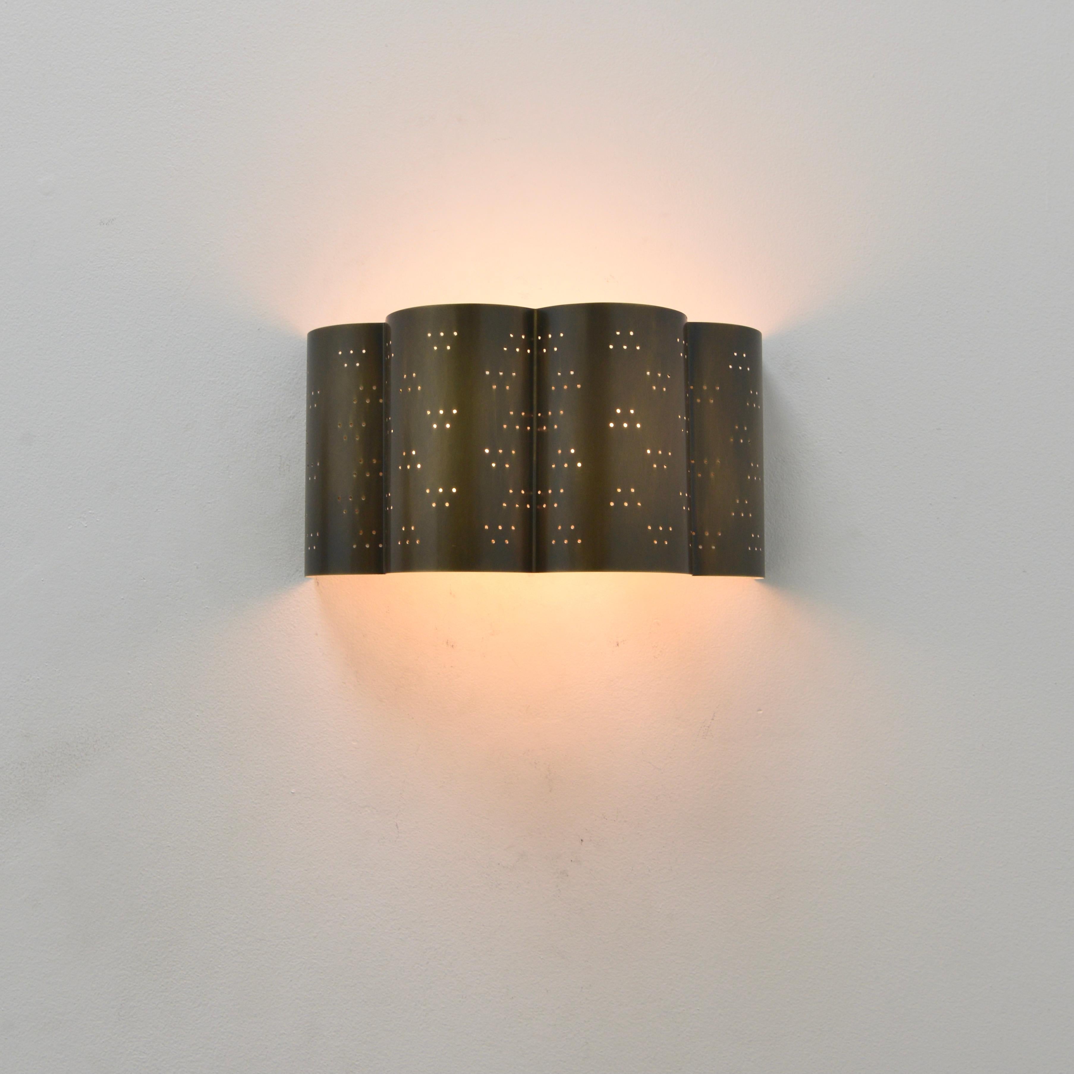 Stunning LUcloud sconce. An all brass patinated and perforated wall sconce by Lumfardo Luminaires. Made contemporary in the US. Multiples available for order. Can be wired for use anywhere in the world. (2) E26 medium based lightbulbs included with