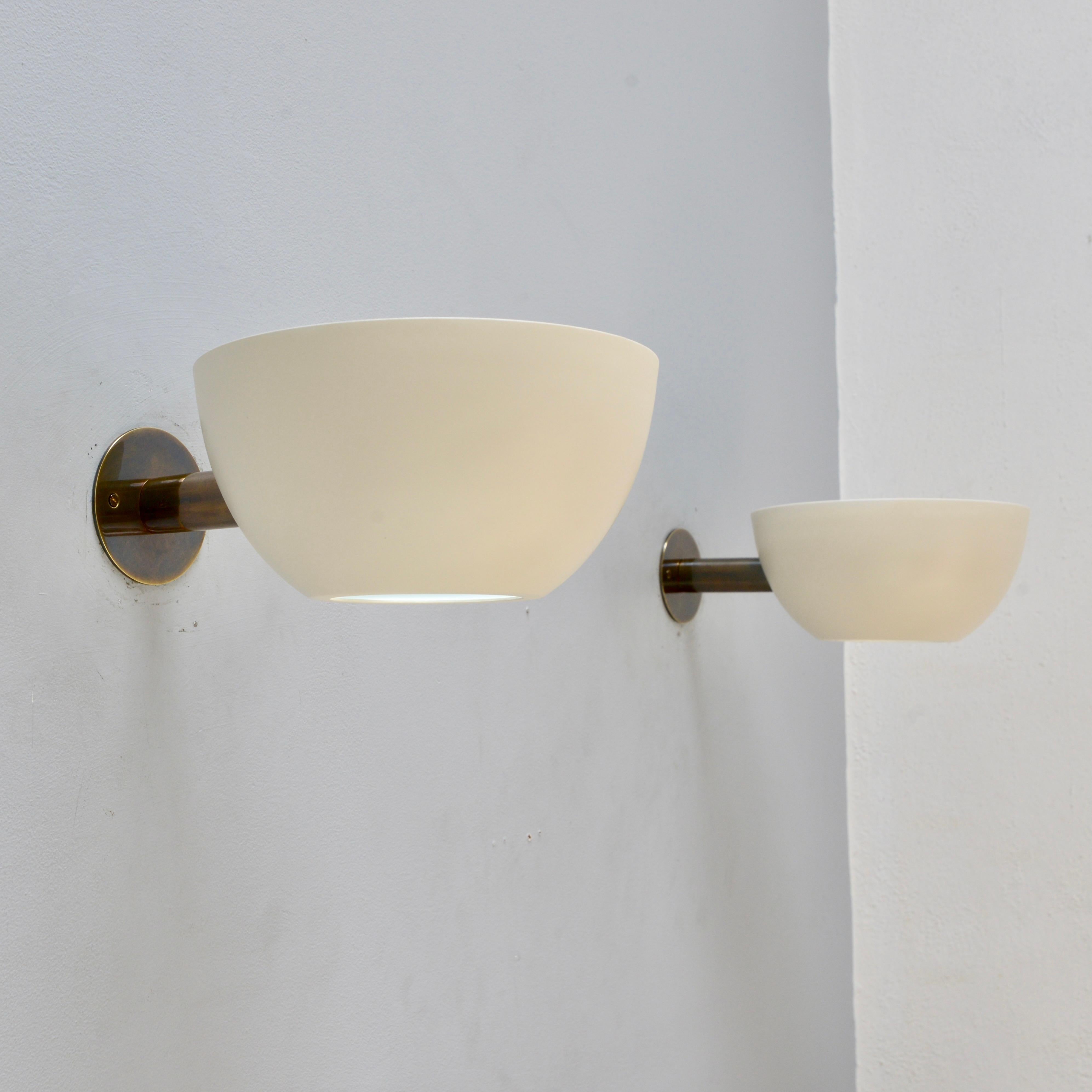 Inspired by 1950s Italian design, this contemporary sconce is a companion piece to our large LUcrown chandelier. Single medium based socket. Painted aluminum shade and patina brass hardware with glass diffuser. Priced individually, multiples