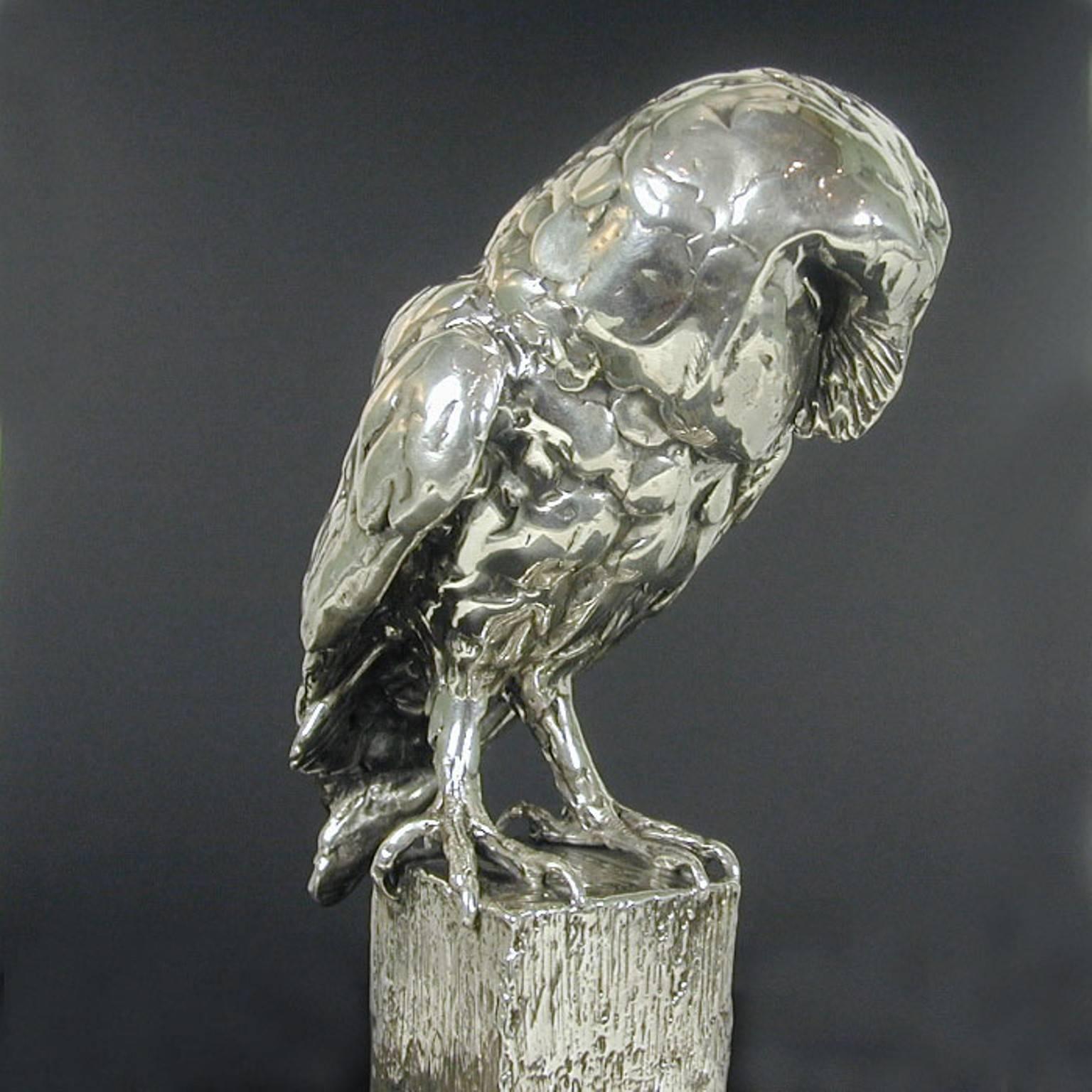 An 'Owl on Post' sterling silver sculpture by Lucy Kinsella, the limited edition finely modelled barn owl perched on the top of a square post, its long curved talons gripping the wood, wings folded close across its back and heart shaped face tilted