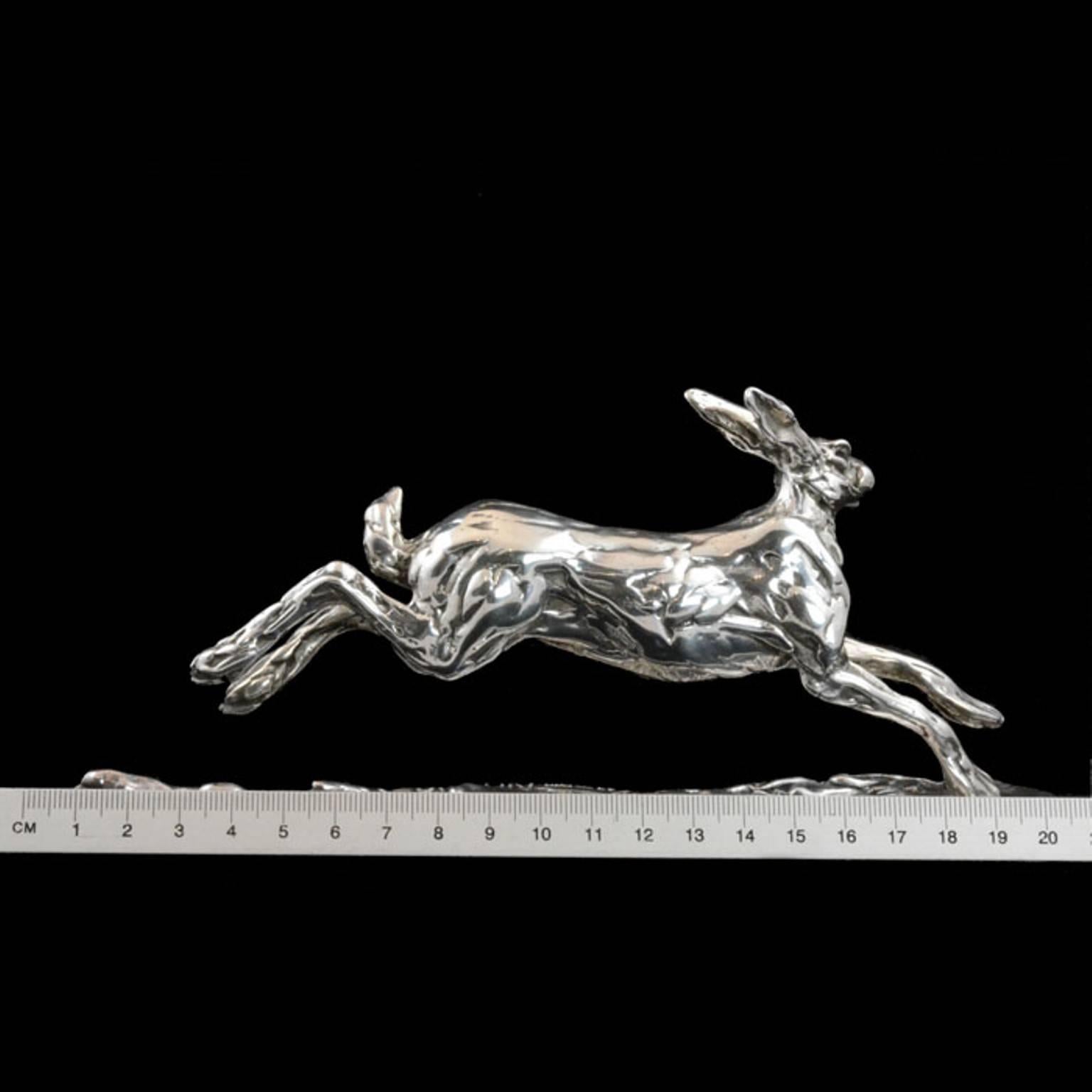 A 'Running Hare' sterling silver sculpture by Lucy Kinsella, the limited edition finely modelled hare depicted at full stretch bounding across the ground, his hind legs lengthening behind him, bob tail upright and head held high. He has been