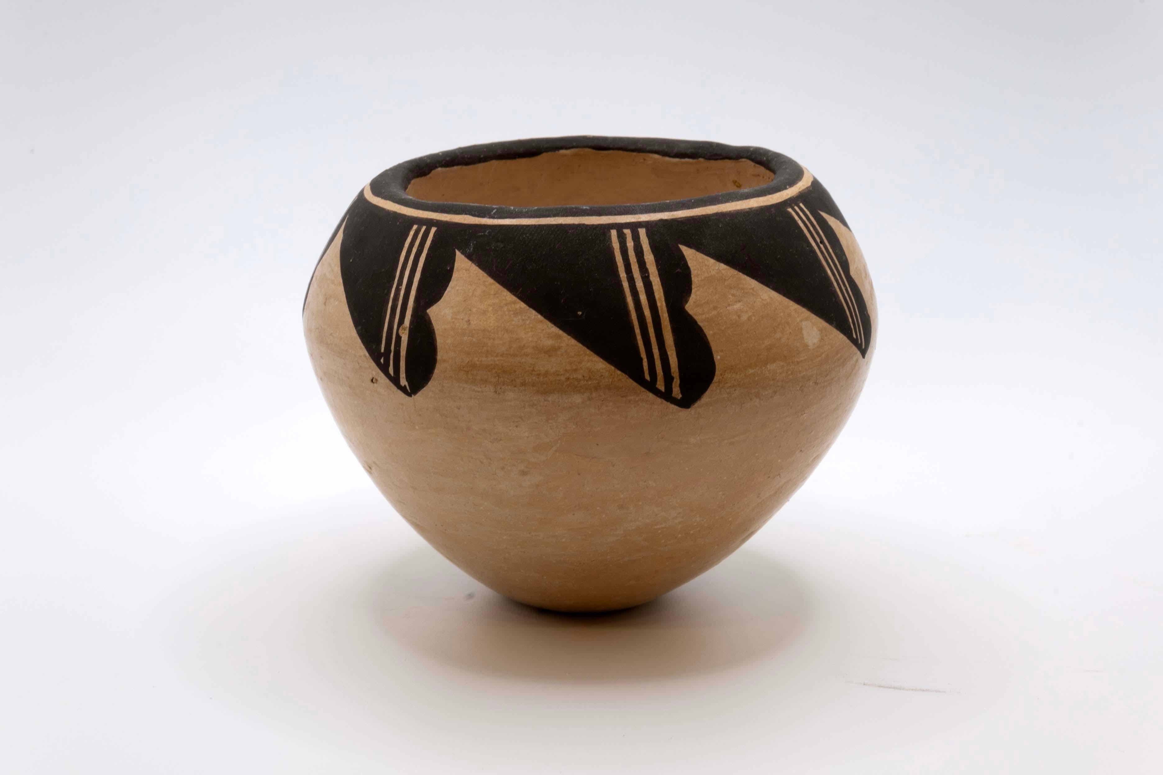 An eclectic set of Pueblo Acoma & Jemez pottery from New Mexico. Each vessel is signed with a different artist’s signature: N. Sandia Jemez (Natalie Sandia), R.D. Jemez, and Lucy M. Lewis. The vessels are fired earthenware with highly stylized