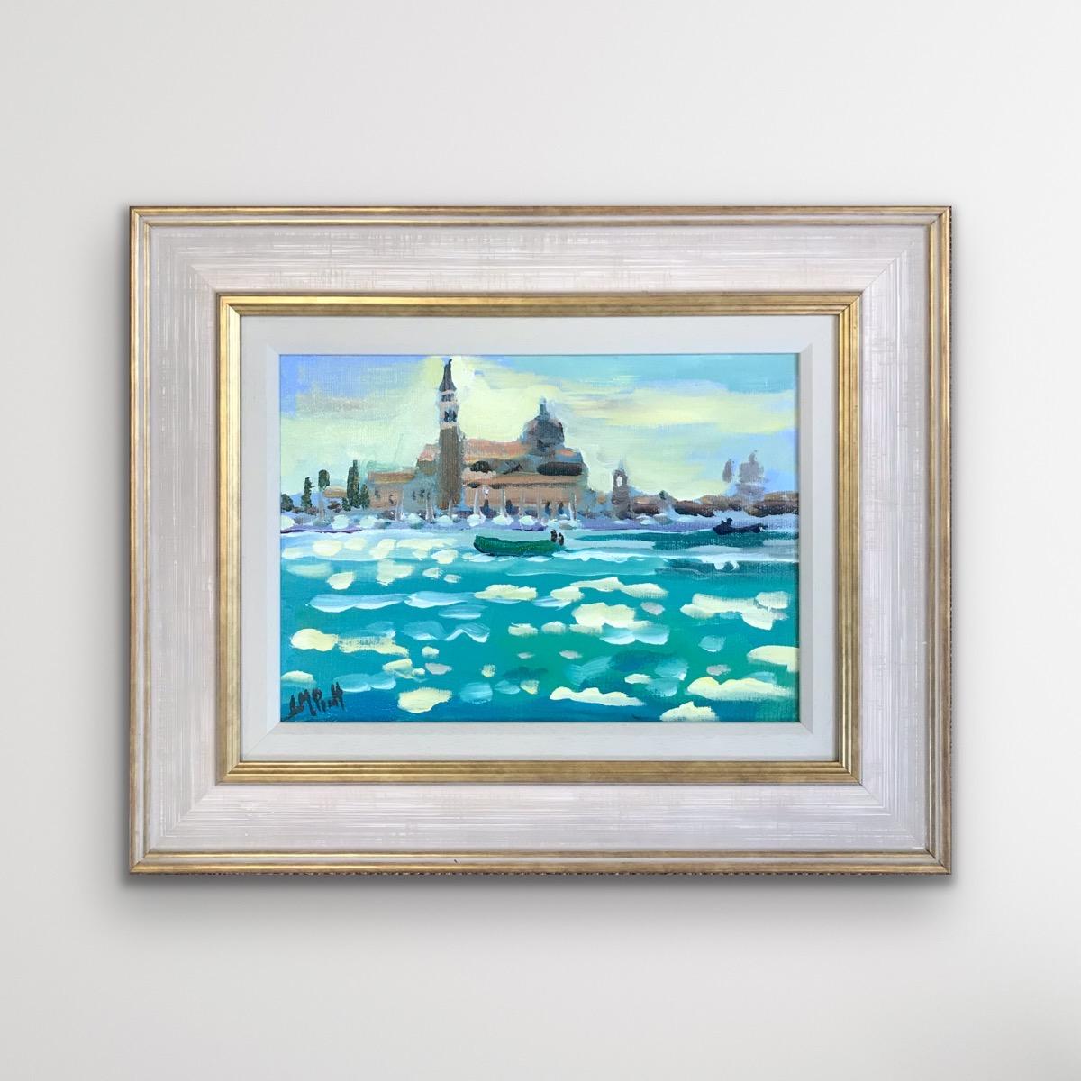 Gondolas At St Mark's, Venice is an original oil on board painting by artist Lucy Pratt. This painting features her beautiful and considered use of impressionist style mark making alongside a vibrant colour palette. Sold framed in a layered white