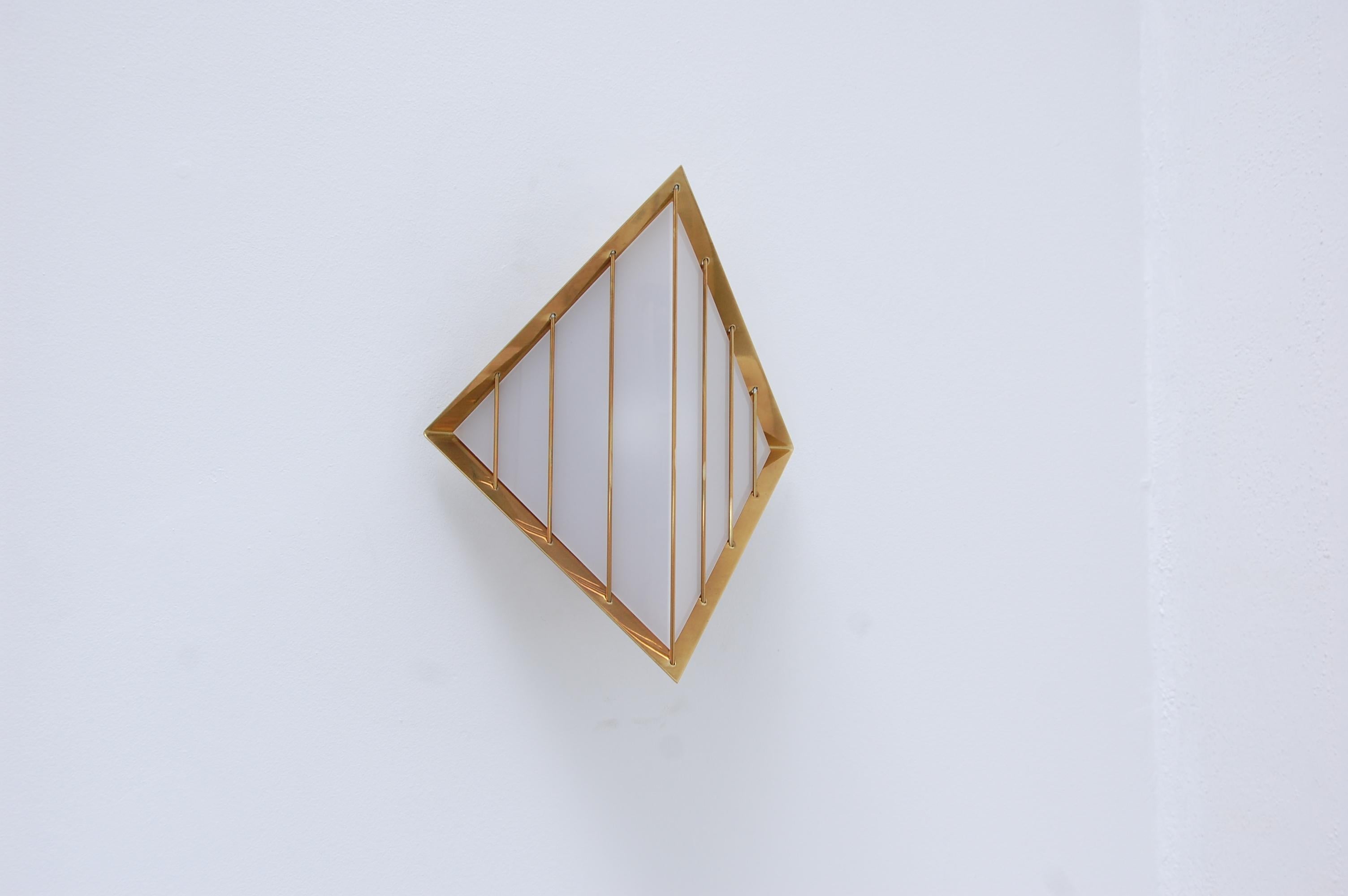 The LUdimanti Sconce is part of Lumfardo Luminaires’ contemporary lighting collection. This diamond shaped brass and acrylic sconce is made to order and can be used either indoor or outdoors. Multiples are available to order. This wall fixture has a