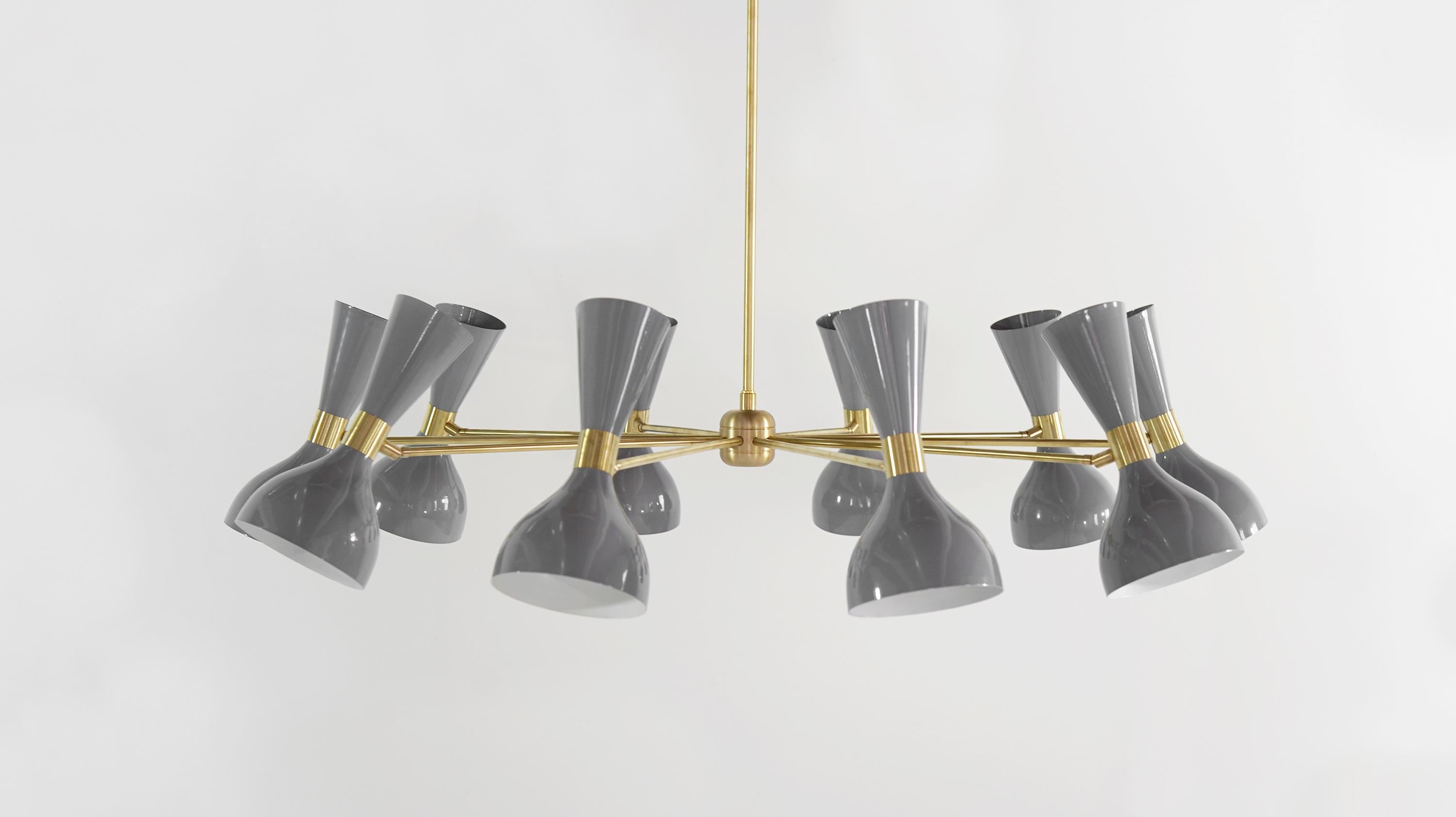 Ludo: an exercise in playful modernism. The large 10-arm round Ludo chandelier proves that good design doesn't have to be so serious! The spun aluminum shades are an iconic vintage mid-century Italian design, while the over-scaled brass band is a