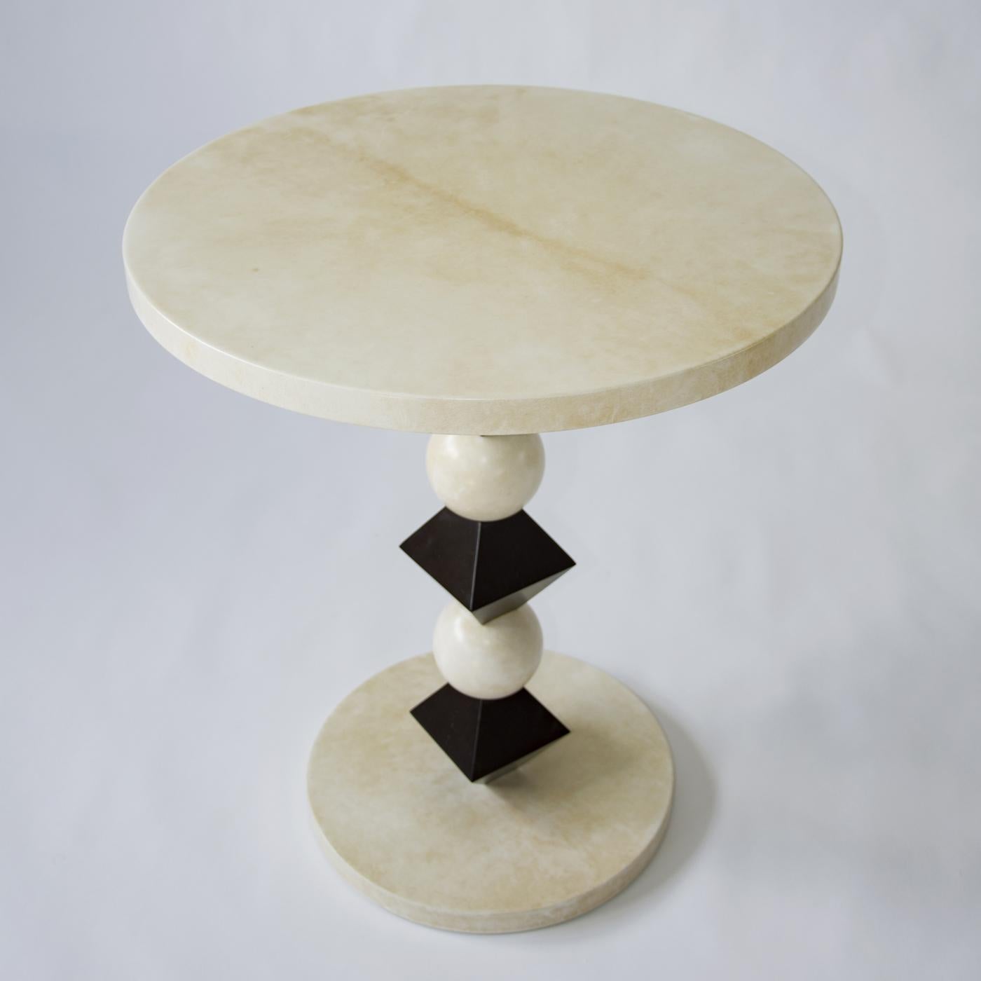 The eye-catching geometric shapes in the pedestal of this original 1980s table by Tura create an appealing aesthetic that will add unique style to a modern living room, entryway, or bedroom decor. Finished with natural parchment, the round top and