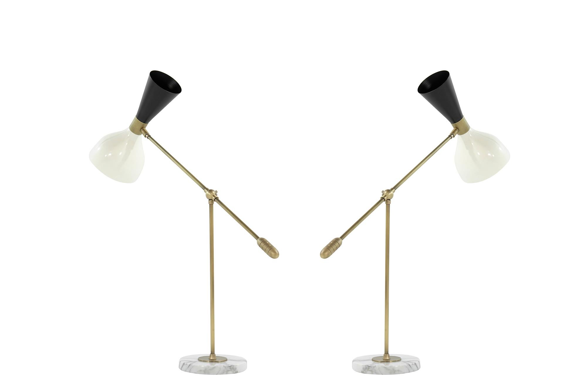 Our best-selling Ludo family of fixtures is now available as a desk or table lamp. Spun aluminum cones are a vintage 1950s Italian design. Swiveling head allows for cone adjustment and the locking joint allows for arm adjustment up and down. The