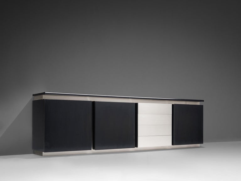 Ludovico Acerbis, sideboard, oak and steel, Italy, 1970s.

This sleek and modern credenza in stainless steel and stained oak is designed by Ludovico Acerbis (1939). This cabinet has both a contemporary yet monumental appearance. The design is