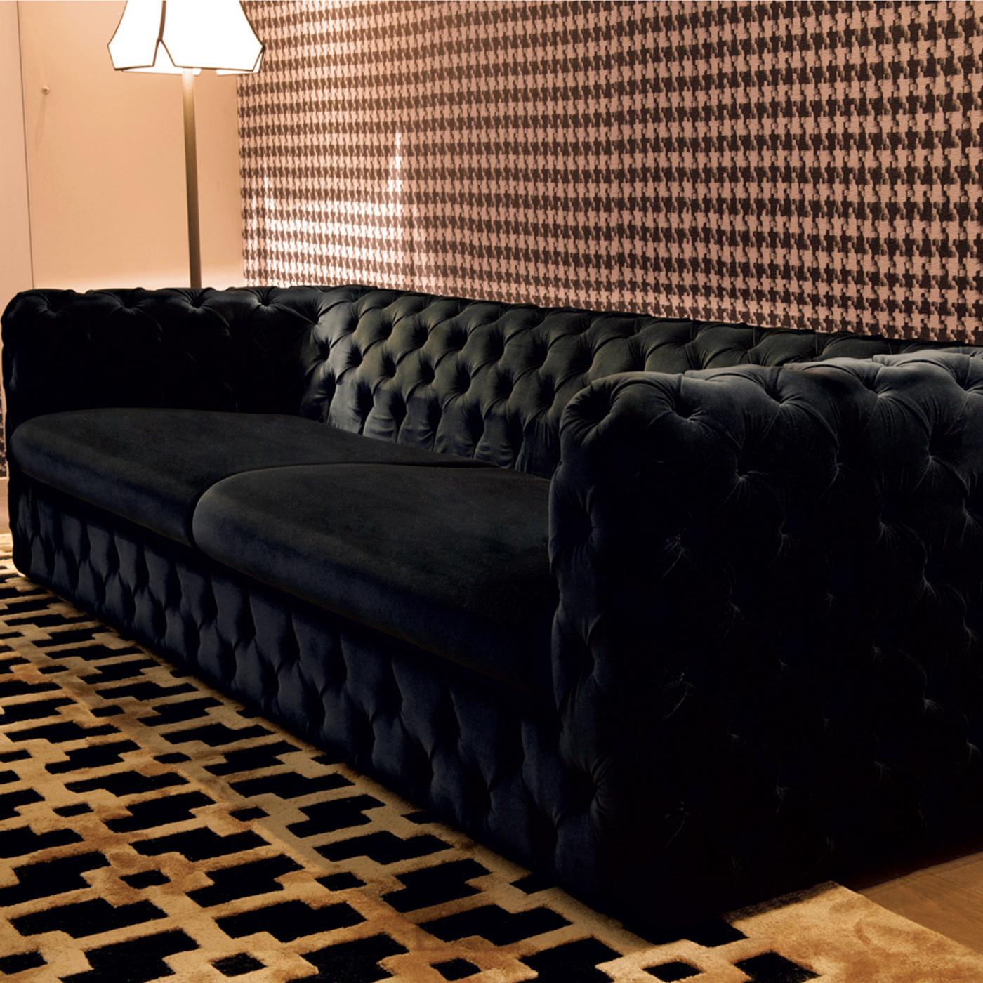 A modern twist on the classic Chesterfield style, this glamorous sofa has a vintage feel that will anchor a modern living room in statement-making style. The streamlined silhouette is padded with multi-density polyurethane and wrapped in a plush,