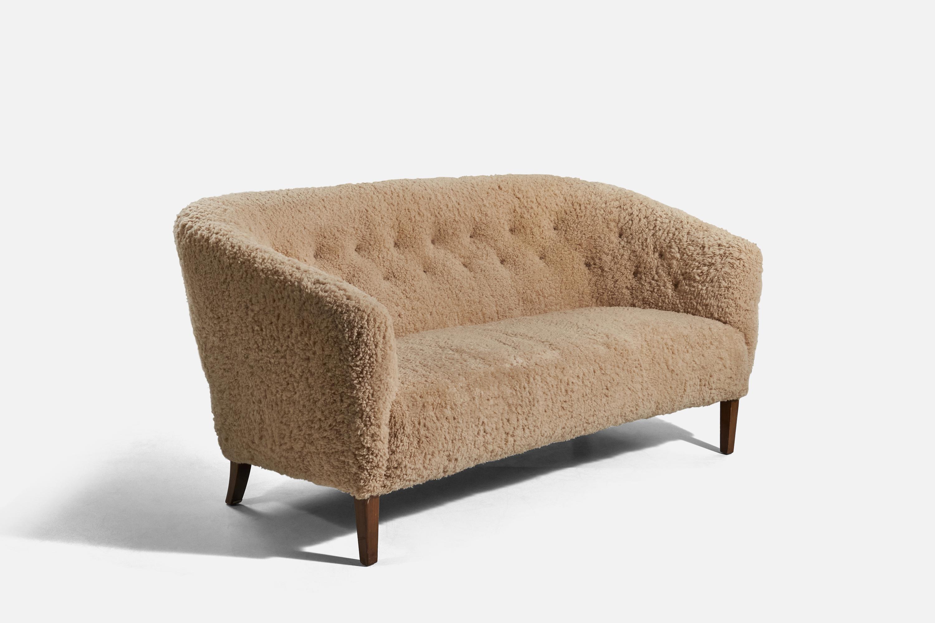 A sheepskin and beech sofa designed and produced by Ludvig Pontoppidan, Denmark, c. 1950s. 