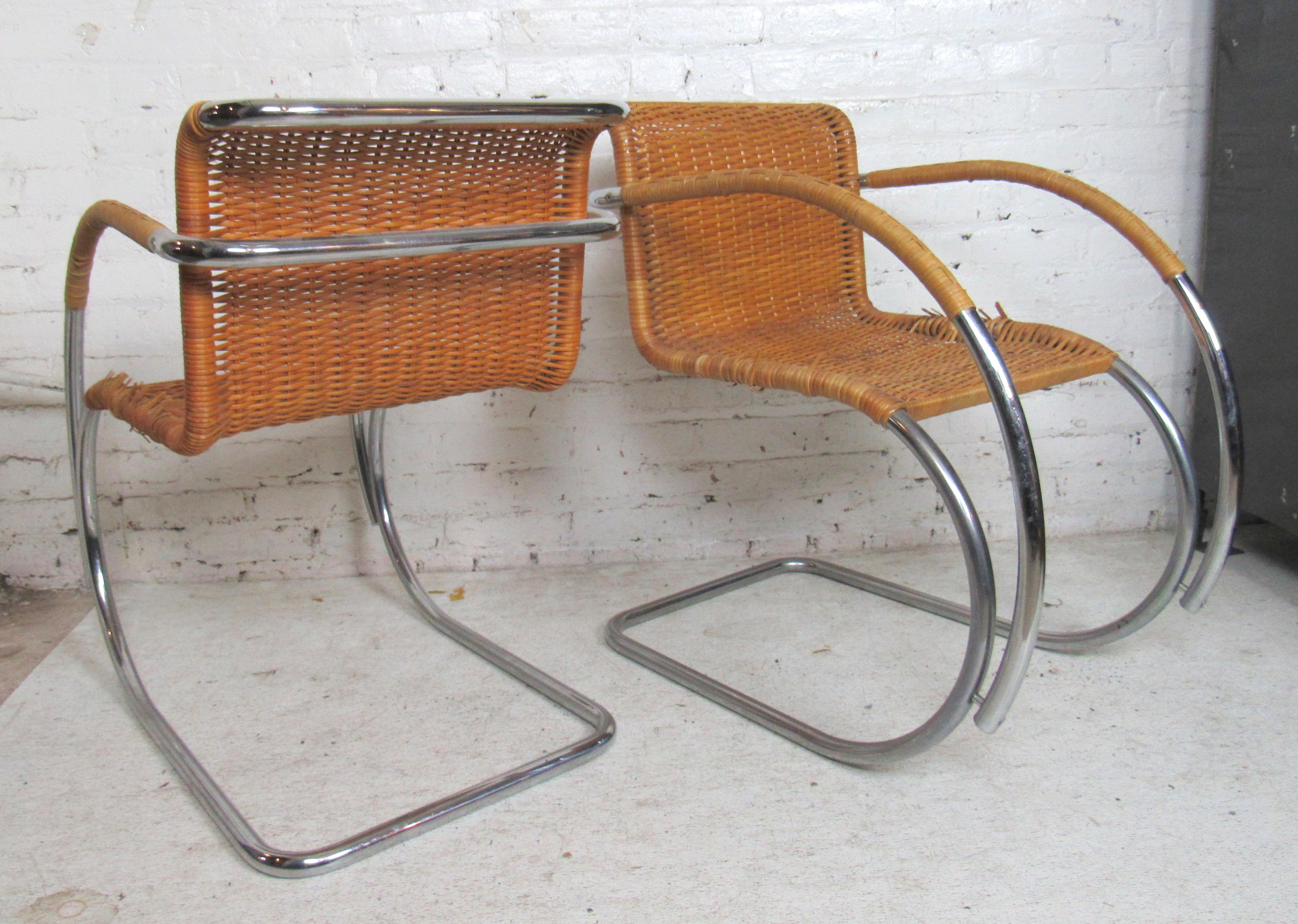 Pair of tubular polished chrome arm chairs with wicker caning.
(Please confirm item location - NY or NJ - with dealer).
  