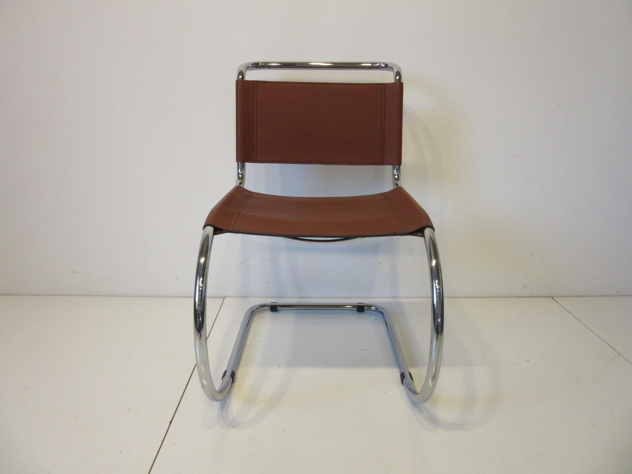 A set of four International Style saddle brown leather and chrome framed cantilever dining chairs designed by Ludwig Mies van der Rohe called the MR -10 chair. The perfect chair for any environment since they span the Machine Age, Art Deco and