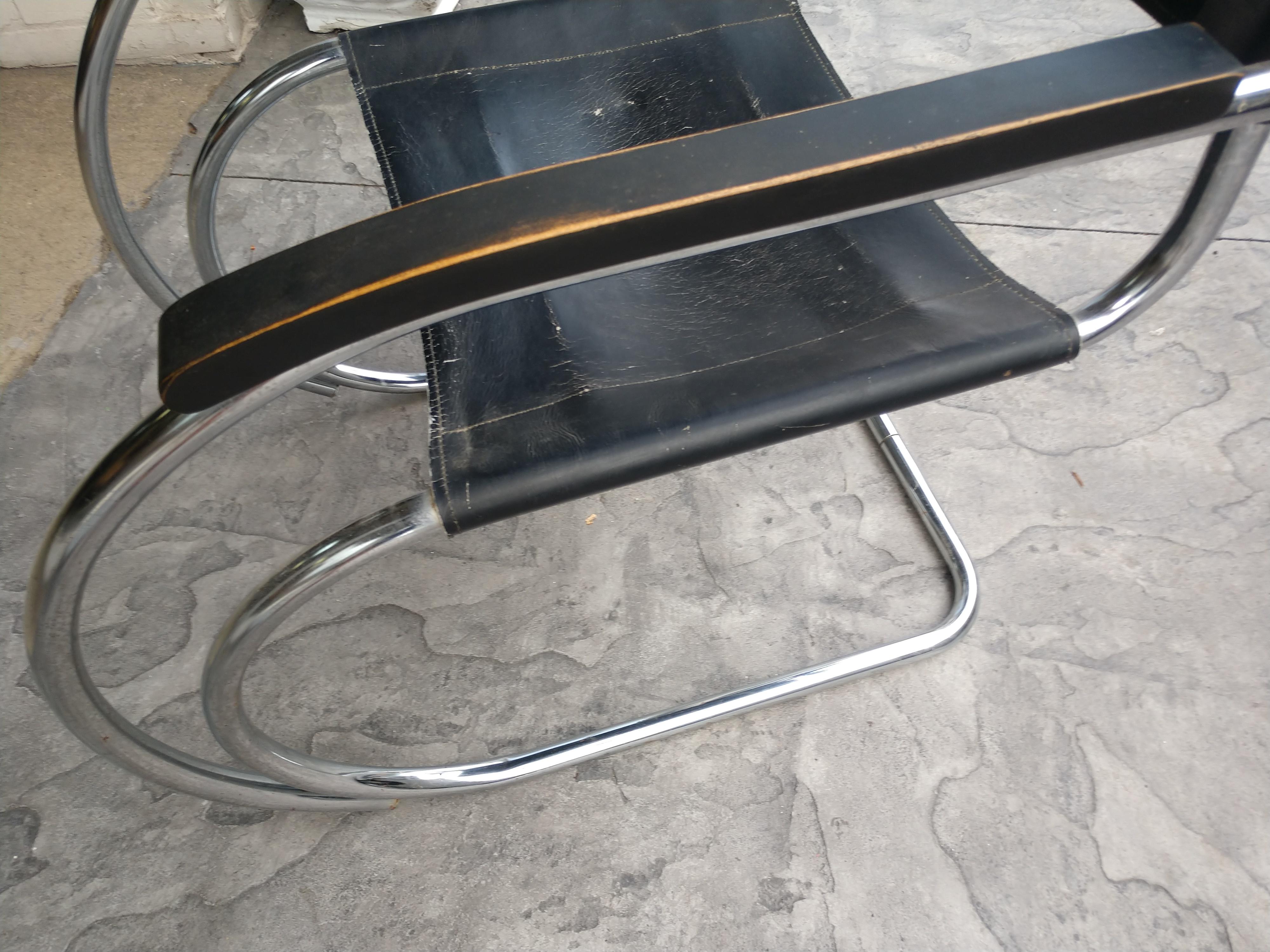 Amazingly timeless chair created in 1926 by Ludwig Mies van der Rohe. Graceful lines in tubular chrome with minimal seat & back but supports so well. This is a 1970s edition of the MR20 possibly by Standing or Knoll. Has wood armrests which are
