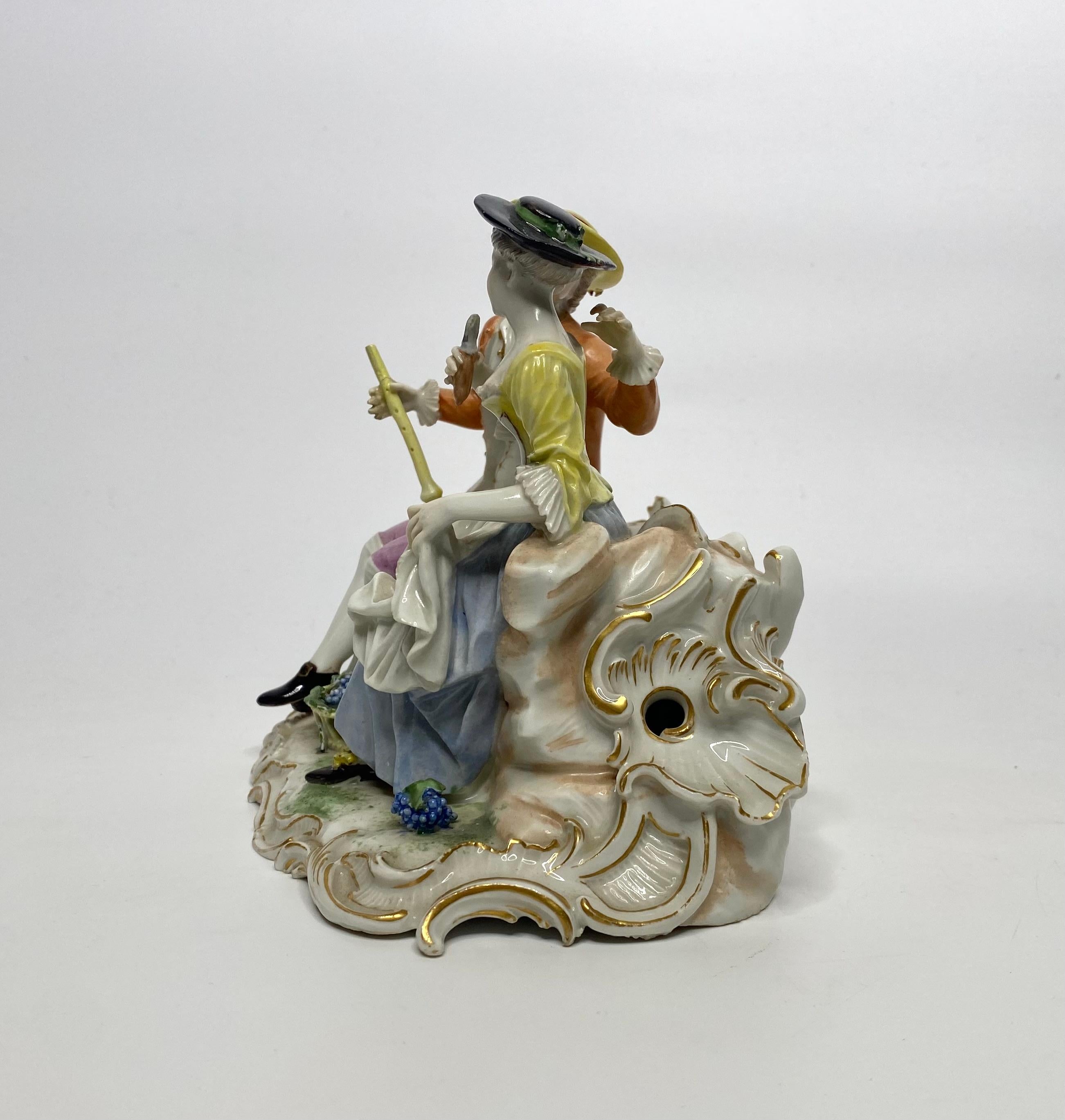 Ludwigsburg porcelain group, modelled by Johann Christoph Haselmeyer, c. 1770. A courting couple, dressed in 18th Century costume, seated upon rocks, before an elaborate rococo scroll architectural feature, edged in gilt.
The boy holds a pipe,