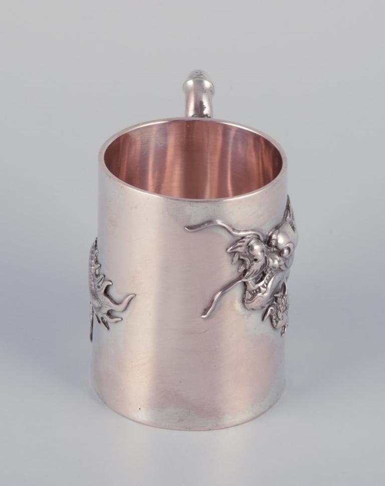 Chinese Export Luen-Wo, Shanghai. Silver cup with handle. Relief dragon motif. 1930s For Sale