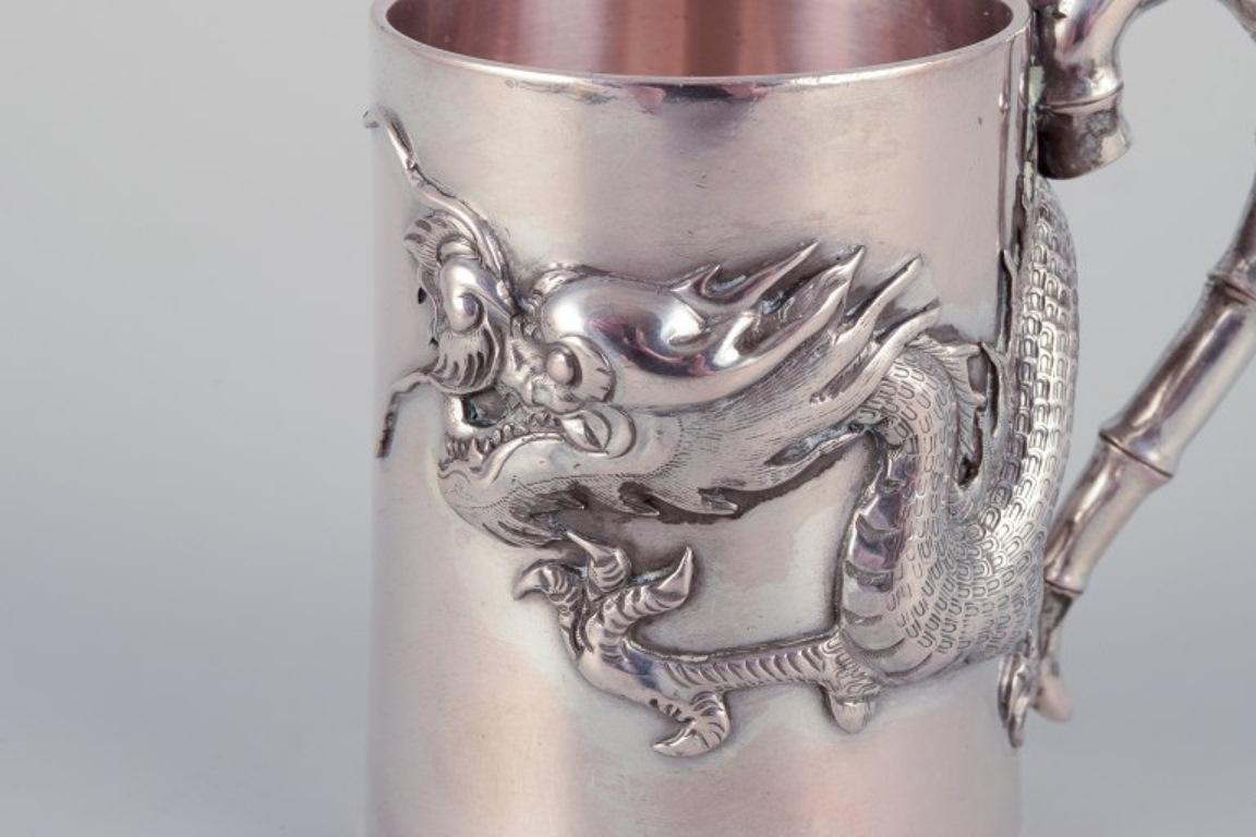 Chinese Luen-Wo, Shanghai. Silver cup with handle. Relief dragon motif. 1930s For Sale