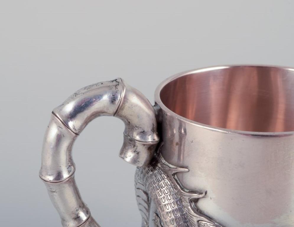 Mid-20th Century Luen-Wo, Shanghai. Silver cup with handle. Relief dragon motif. 1930s For Sale