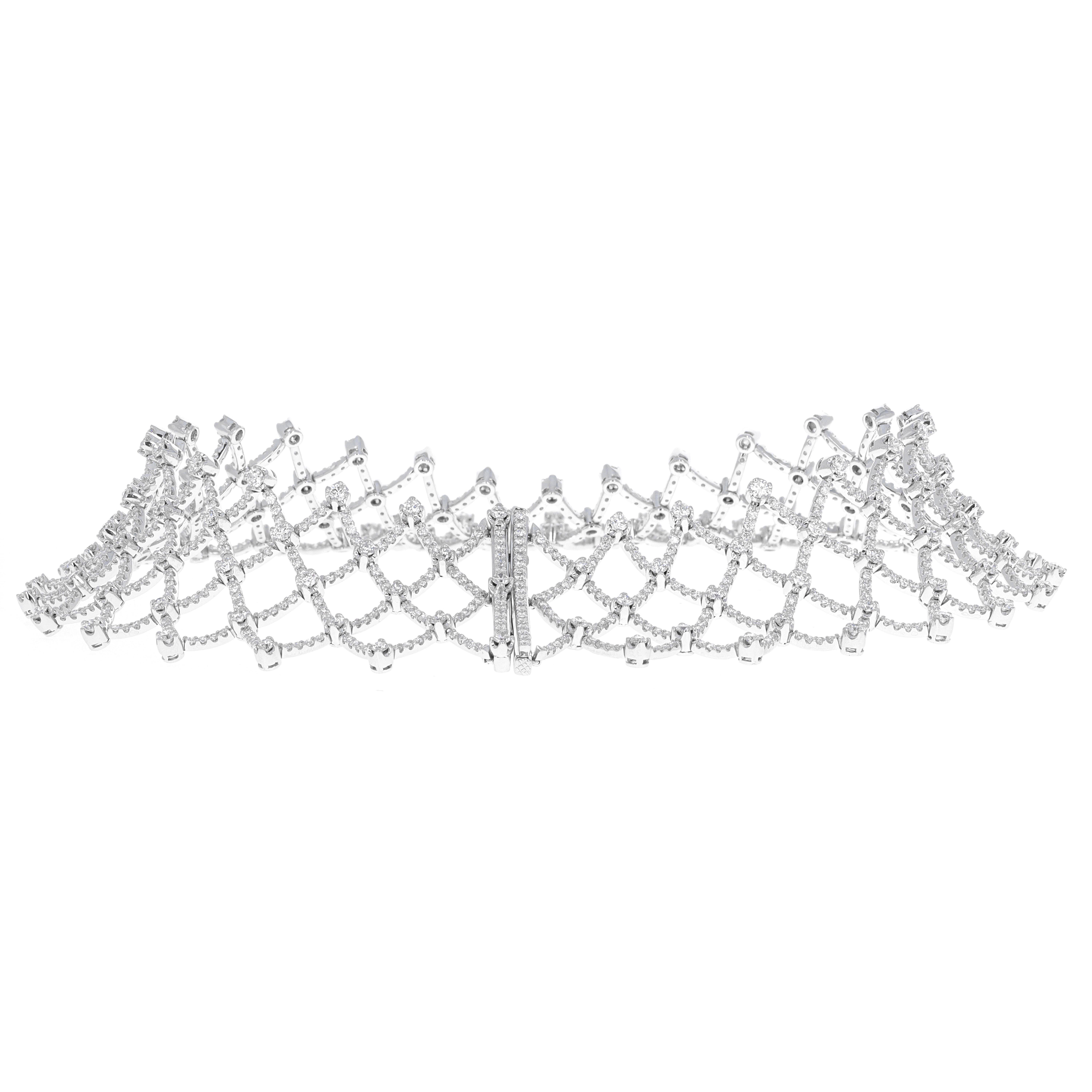 Lugano diamond collar necklace that can also be worn as a tiara. This piece is timeless and very versitile. It is made in 18 karat white gold and has great movement and flexibility. There is 28.32 carats total weight of white eye clean diamonds. The