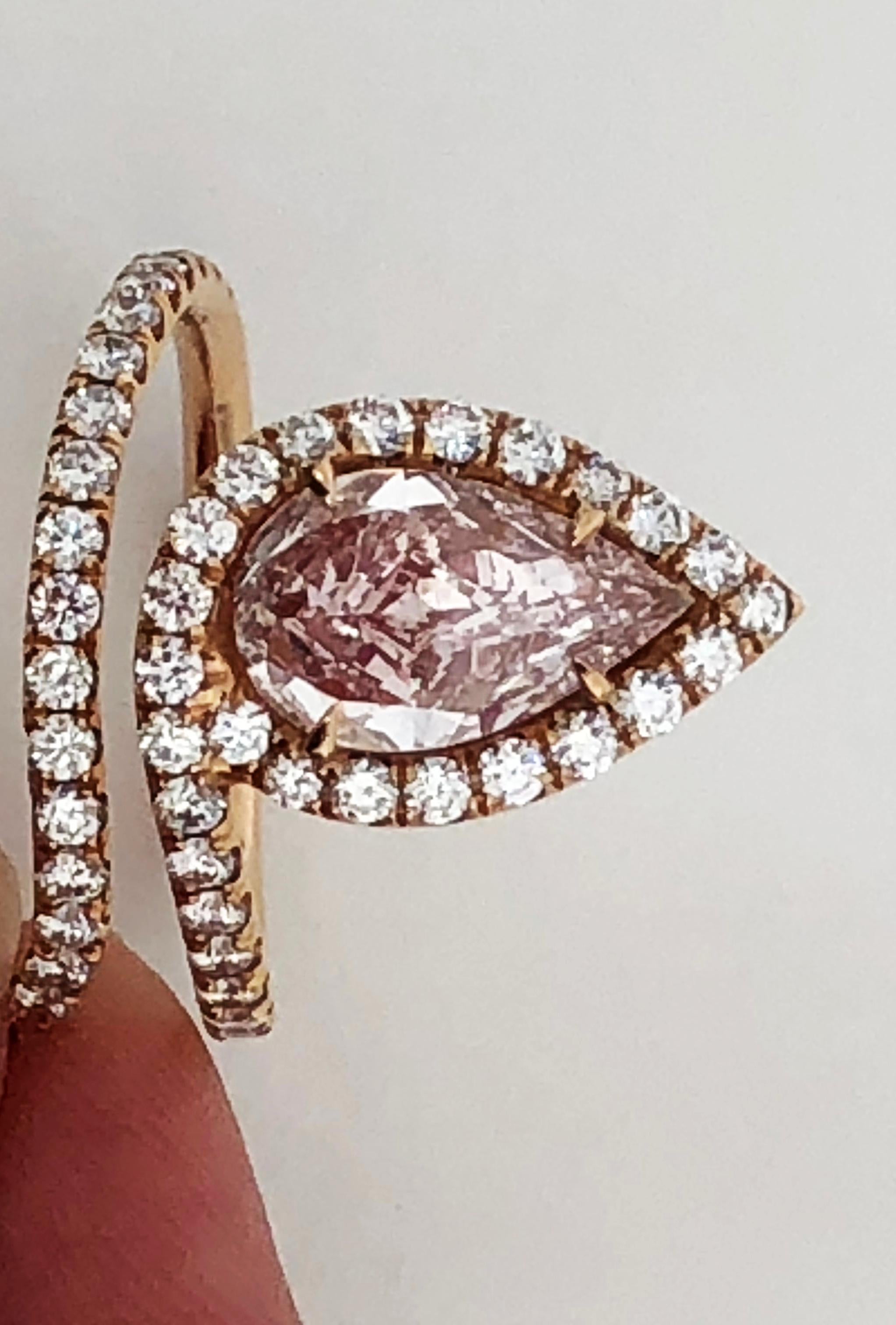 Gorgeous natural fancy light pink pear shape diamond weighing 1.72 ct with 1.00 ct of white diamond rounds in a handcrafted 18k rose gold mounting.   VS1 clarity. GIA certificate available.  Stone is exceptionally spready and has very strong color. 