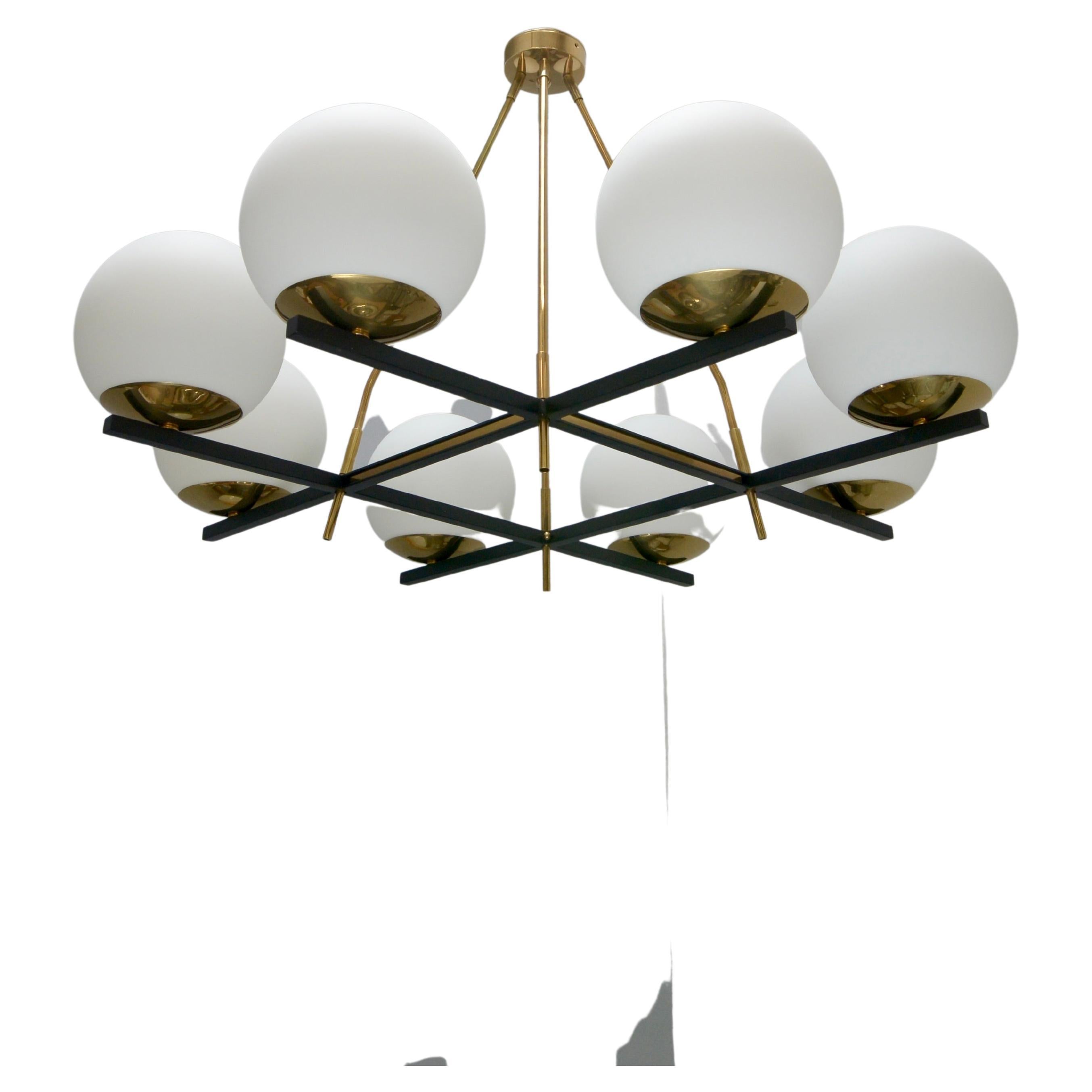 Stunning LUglo flush mount chandelier, an 8 globe glass shade flush mount/chandelier inspired by classical mid century Italian design. Made in glass, steel, aluminum and aged brass. Featuring an elegant grid pattern, this fixture is wired with 1-E12
