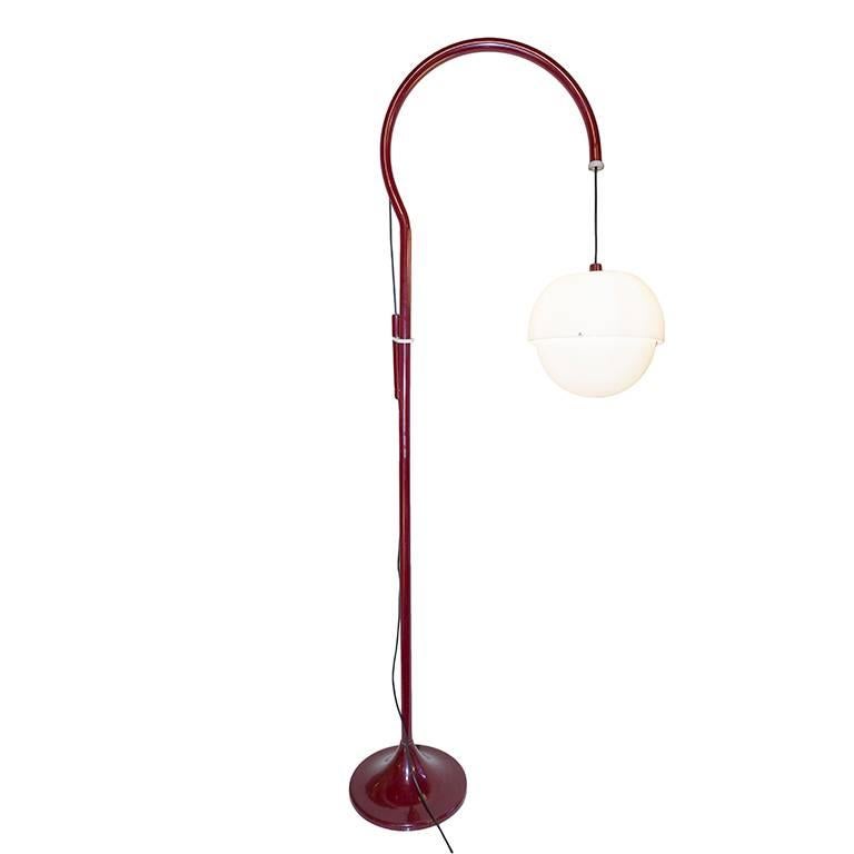 Red floor lamp in lacquered metal and acrylic. Height of globe can be adjusted by pulley and counter balanced weight. The metal arm that holds the globe rotates. All original condition.