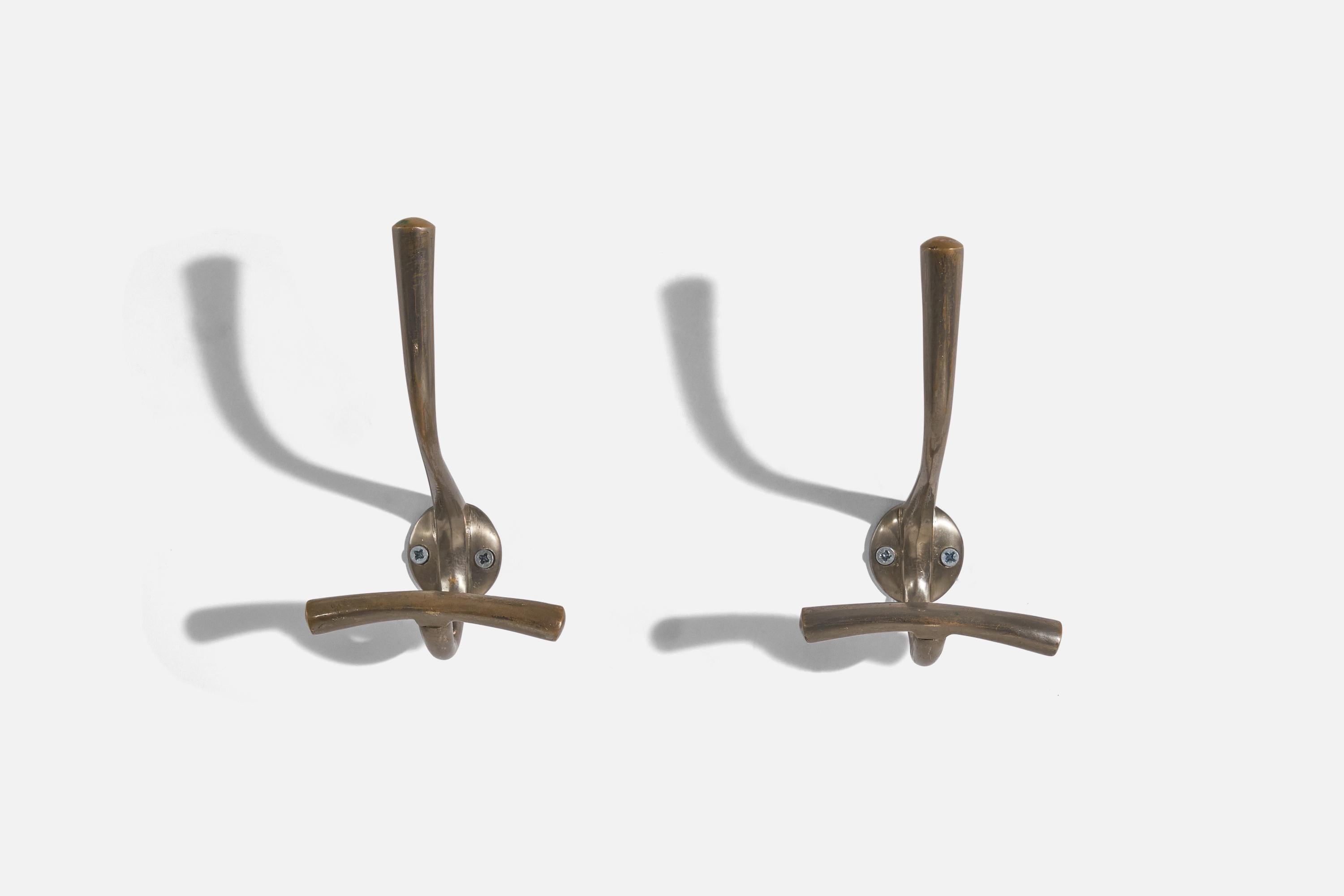 A pair of metal coat hangers designed and produced by Luigi Caccia Dominioni, Italy, 1950s.

