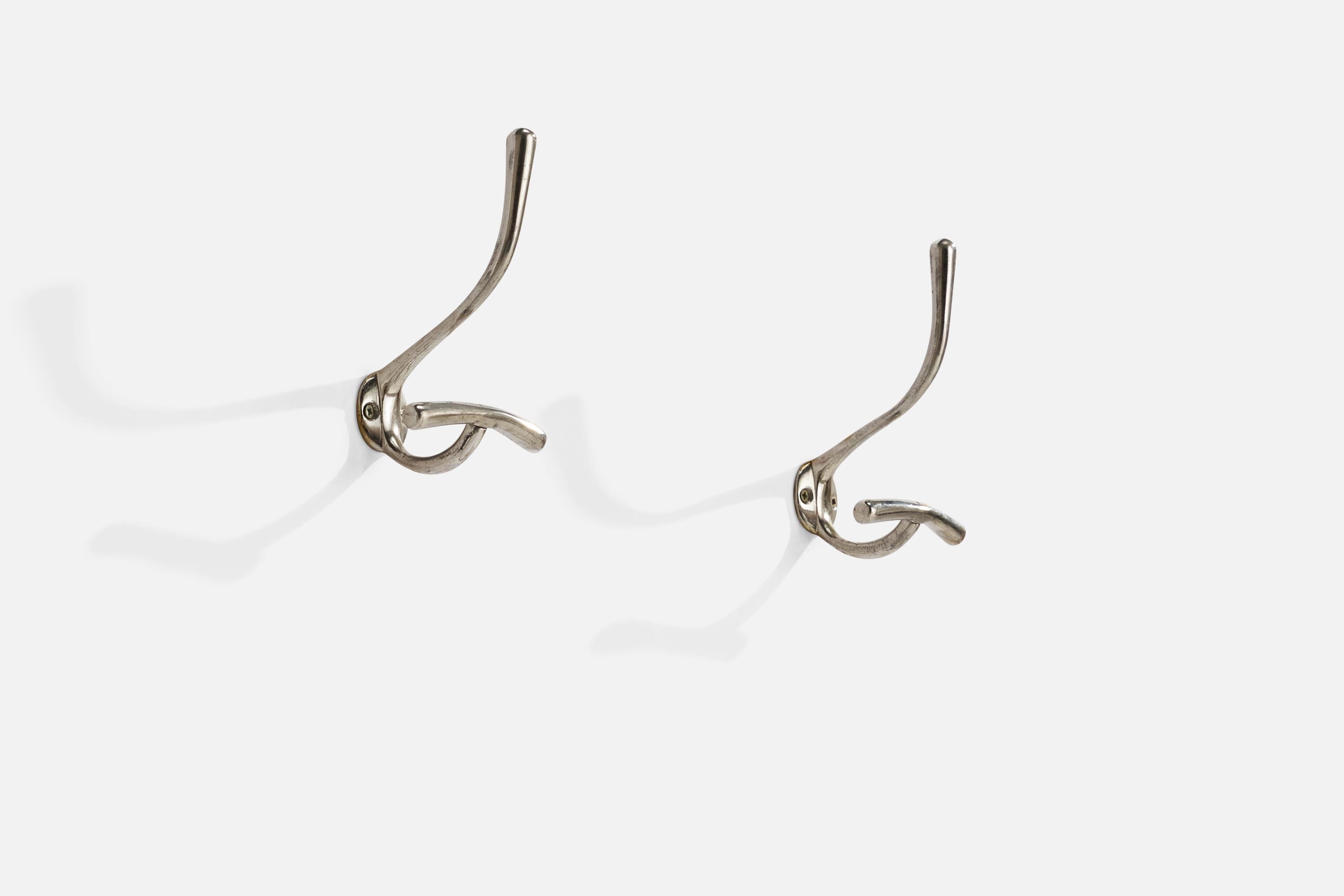 A pair of nickel-plated brass wall hangers designed by Luigi Caccia Dominioni and produced by Azucena, Italy, 1950s.