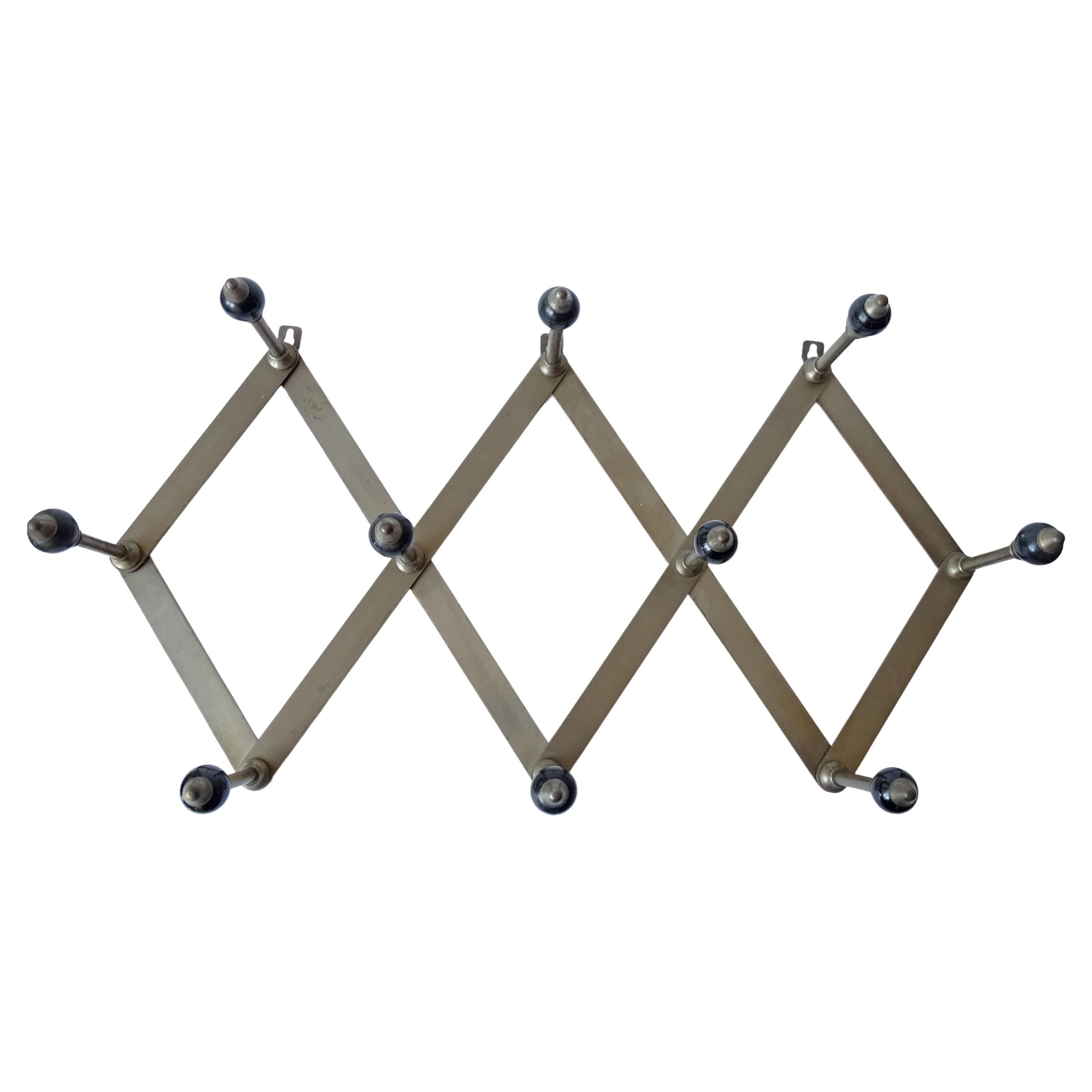 Luigi Caccia Dominioni Model A4 coat rack for Azucena in nickel-plated brass and black resin globes, Italy, 1950s.
