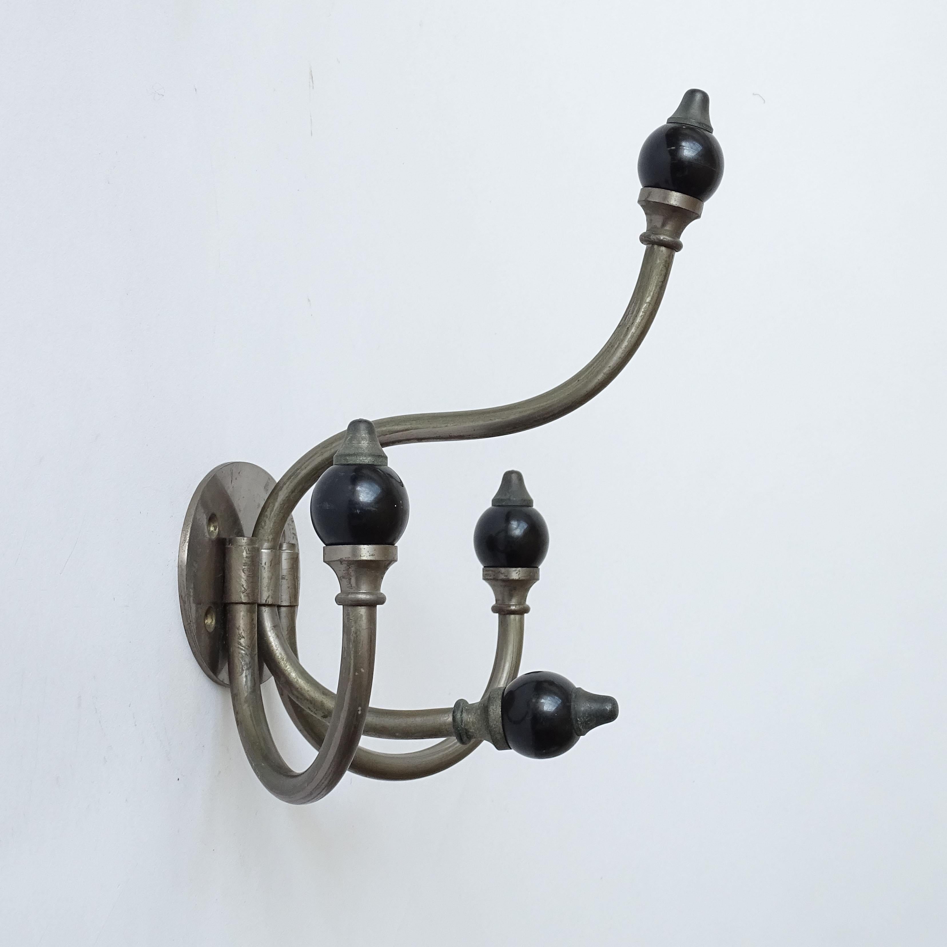 Luigi Caccia Dominioni wall coat rack for Azucena in nickel-plated brass and black resin globes, Italy, 1950s.
