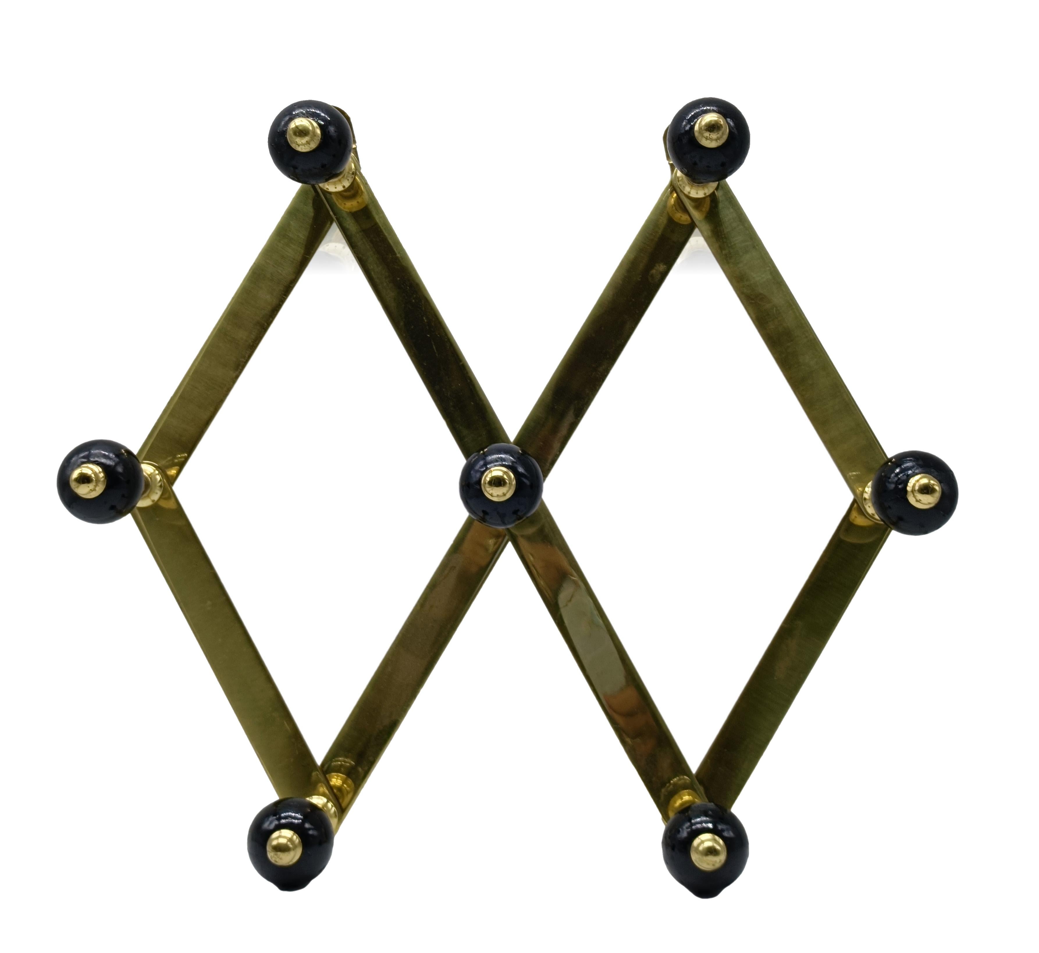 Adjustable brass and Bakelite coat stand by Luigi Caccia Dominioni for Azucena. Adjustable brass frame with black Bakelite knobs.
Excellent condition.