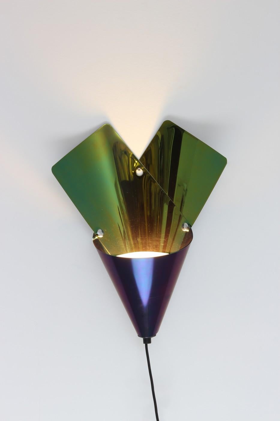 Electro-colored steel, chrome-plated studs, the shape of the Azucena Cartoccio wall light is inspired by the paper cones Milanese street vendors sell hot chestnuts. A combination of old and new, the piece makes a bold statement while providing